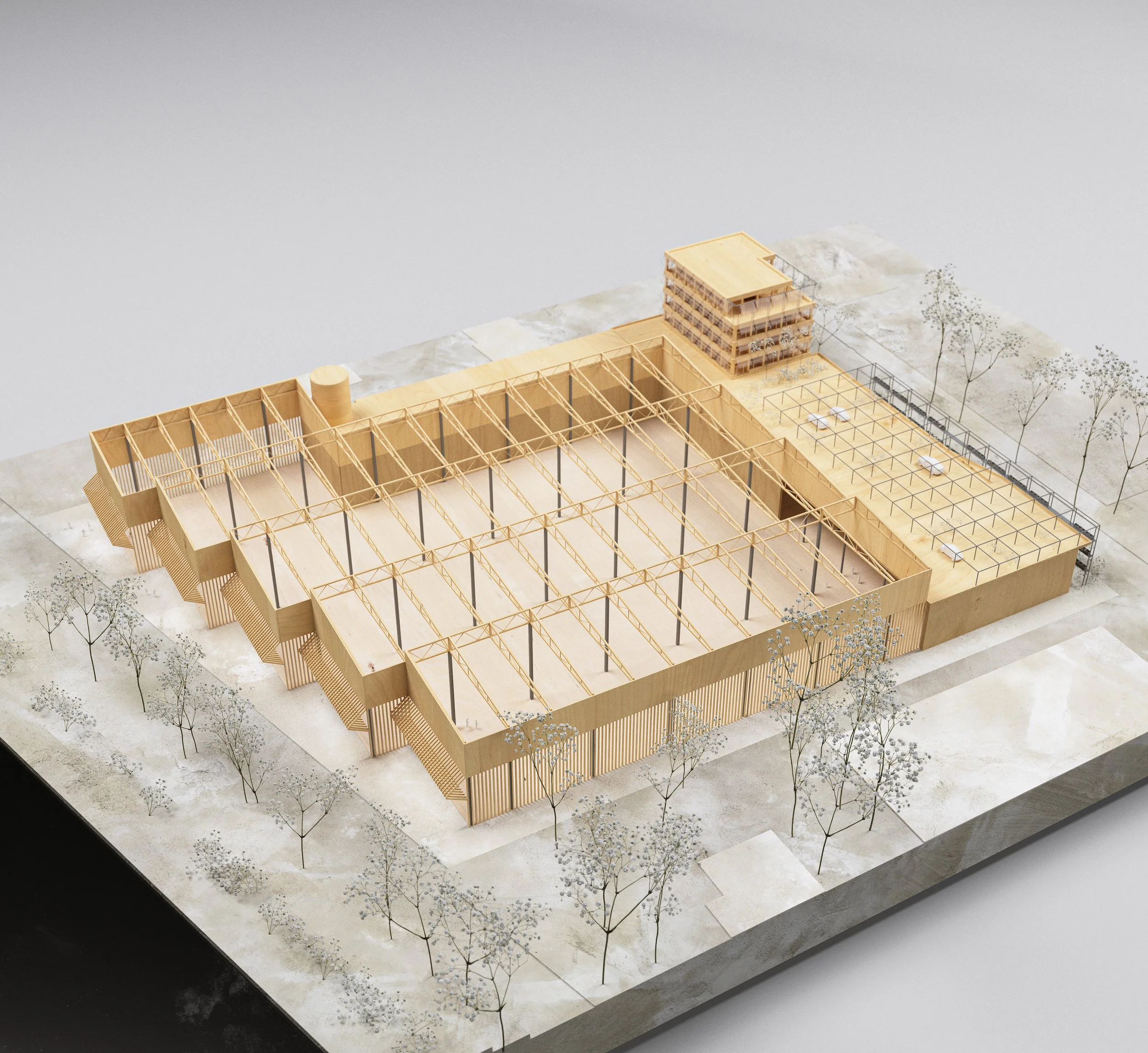 Architectural model of a large wooden building with a grid-like framework, surrounded by trees and an open outdoor area with picnic tables, and a smaller multi-story structure at one corner.