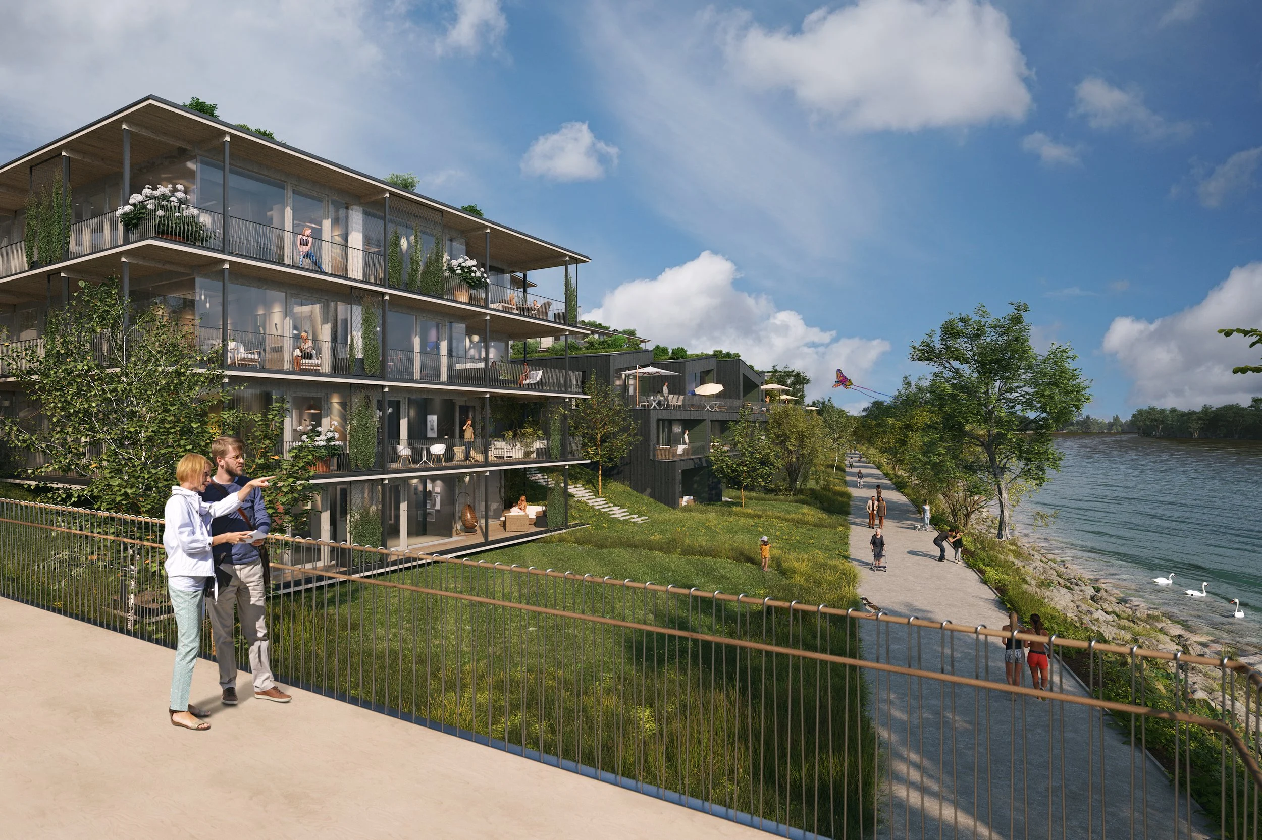 Modern residential building with multiple floors and balconies situated along a riverbank, with people walking and relaxing outside.
