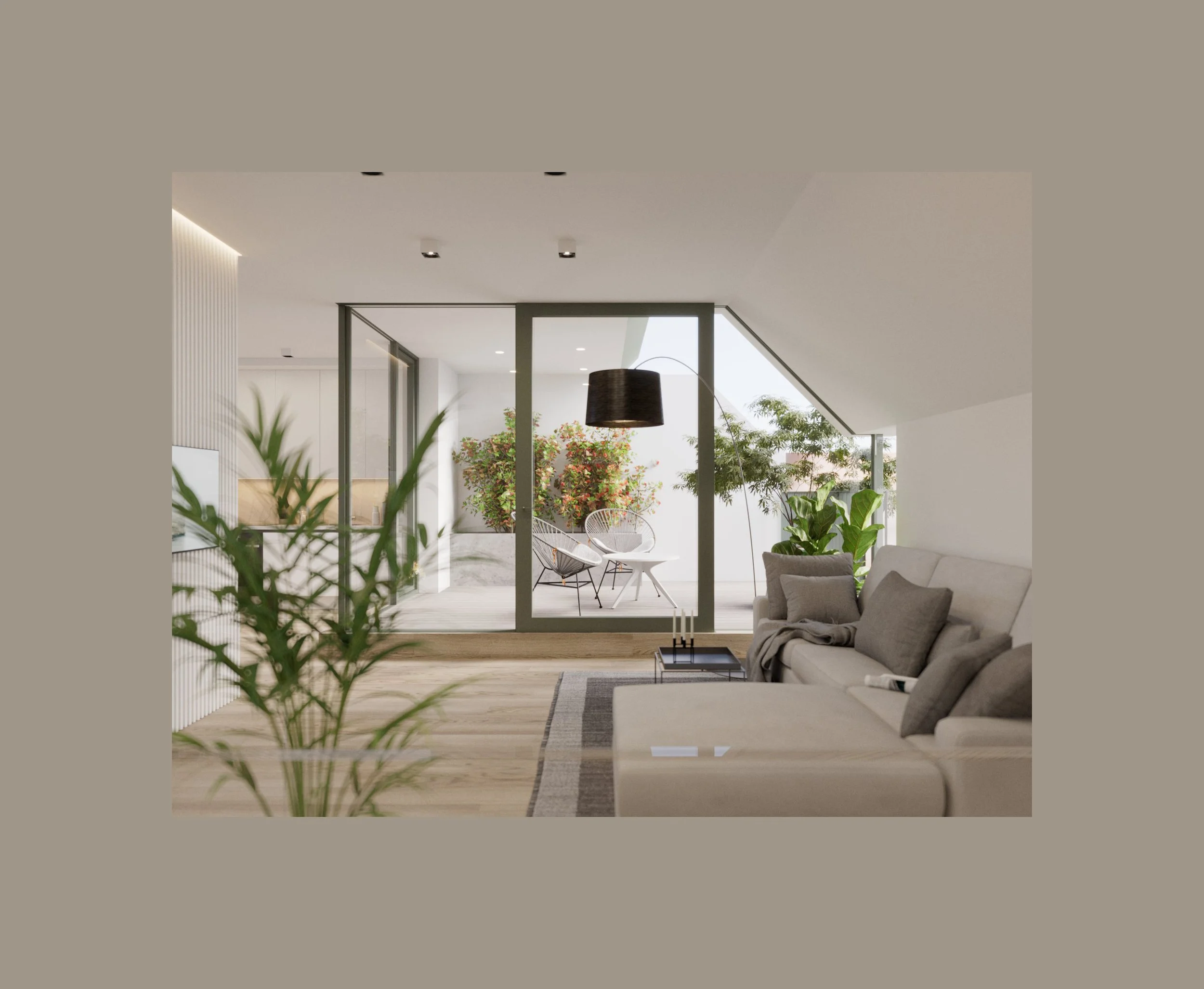 Modern living room with a beige sofa, gray pillows, potted plants, and a view of a balcony with outdoor chairs and greenery.