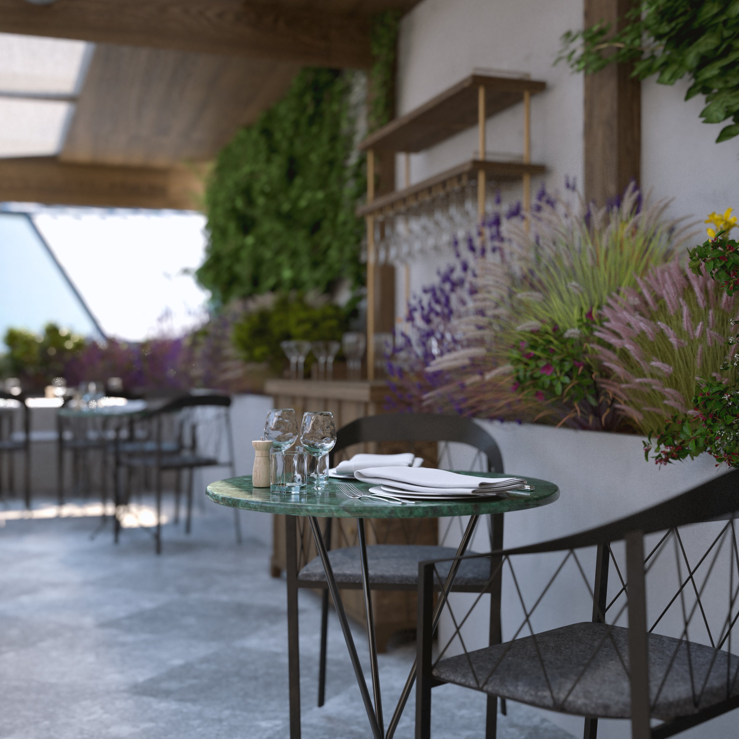 Empty outdoor dining table with glasses, napkins, and utensils in a restaurant with modern decor and floral plants.
