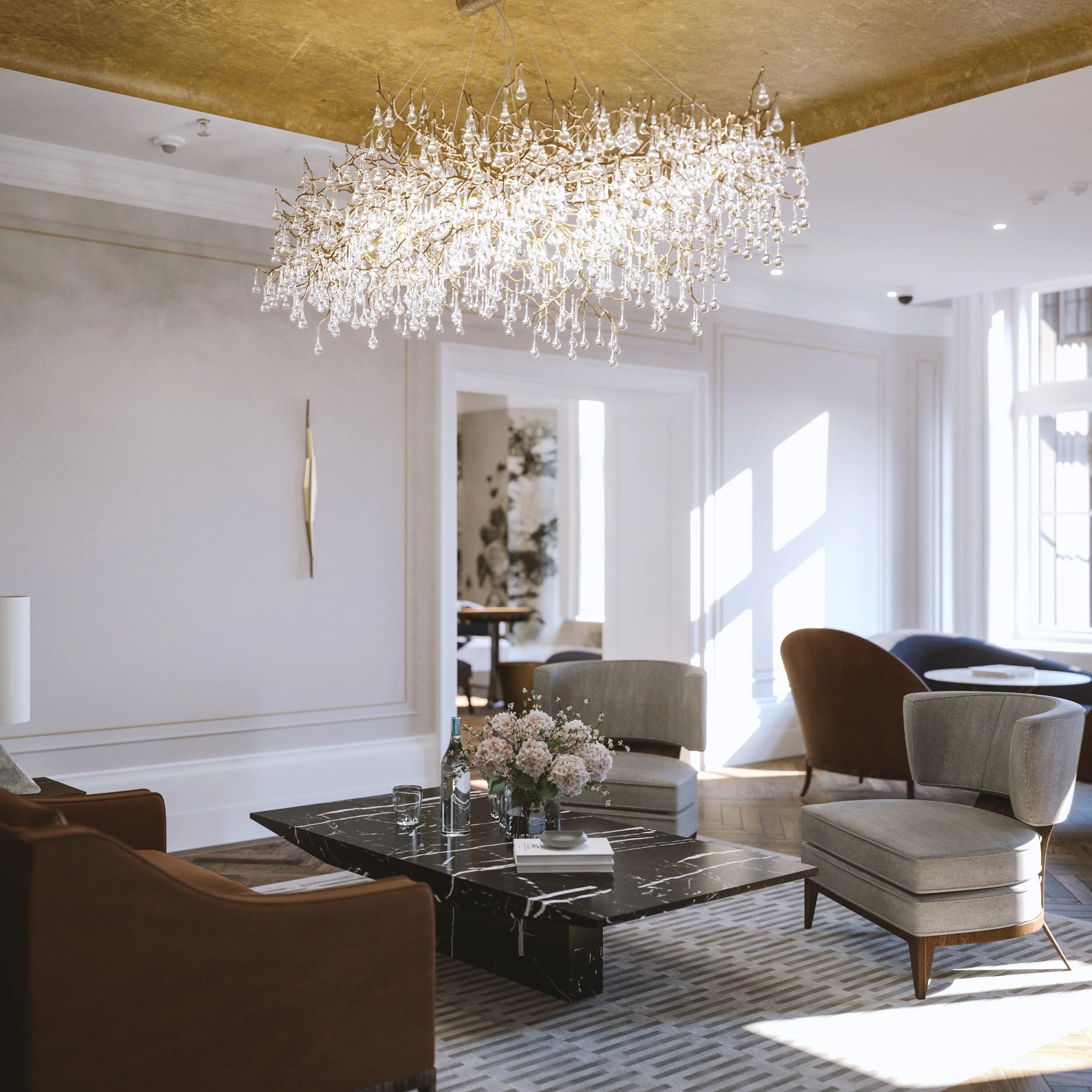 Elegant living room with a gold ceiling, crystal chandelier, white walls, beige, gray, and brown furniture, black marble coffee table with a flower arrangement, and natural light streaming through large windows.