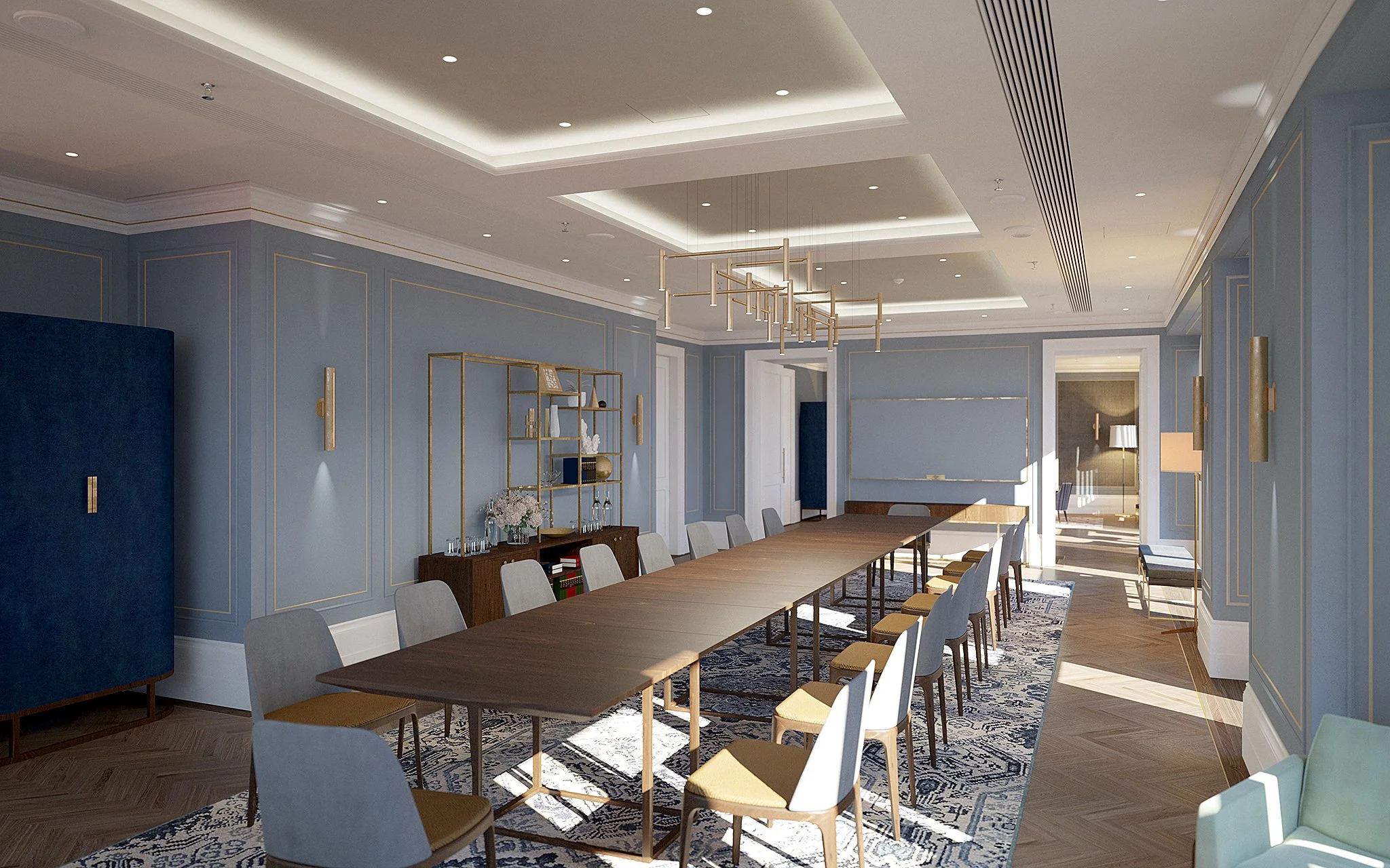 Elegant conference room with a long wooden table surrounded by white chairs with yellow cushions, blue paneled walls, a patterned rug, and a modern gold chandelier, with sunlight streaming in through the windows.