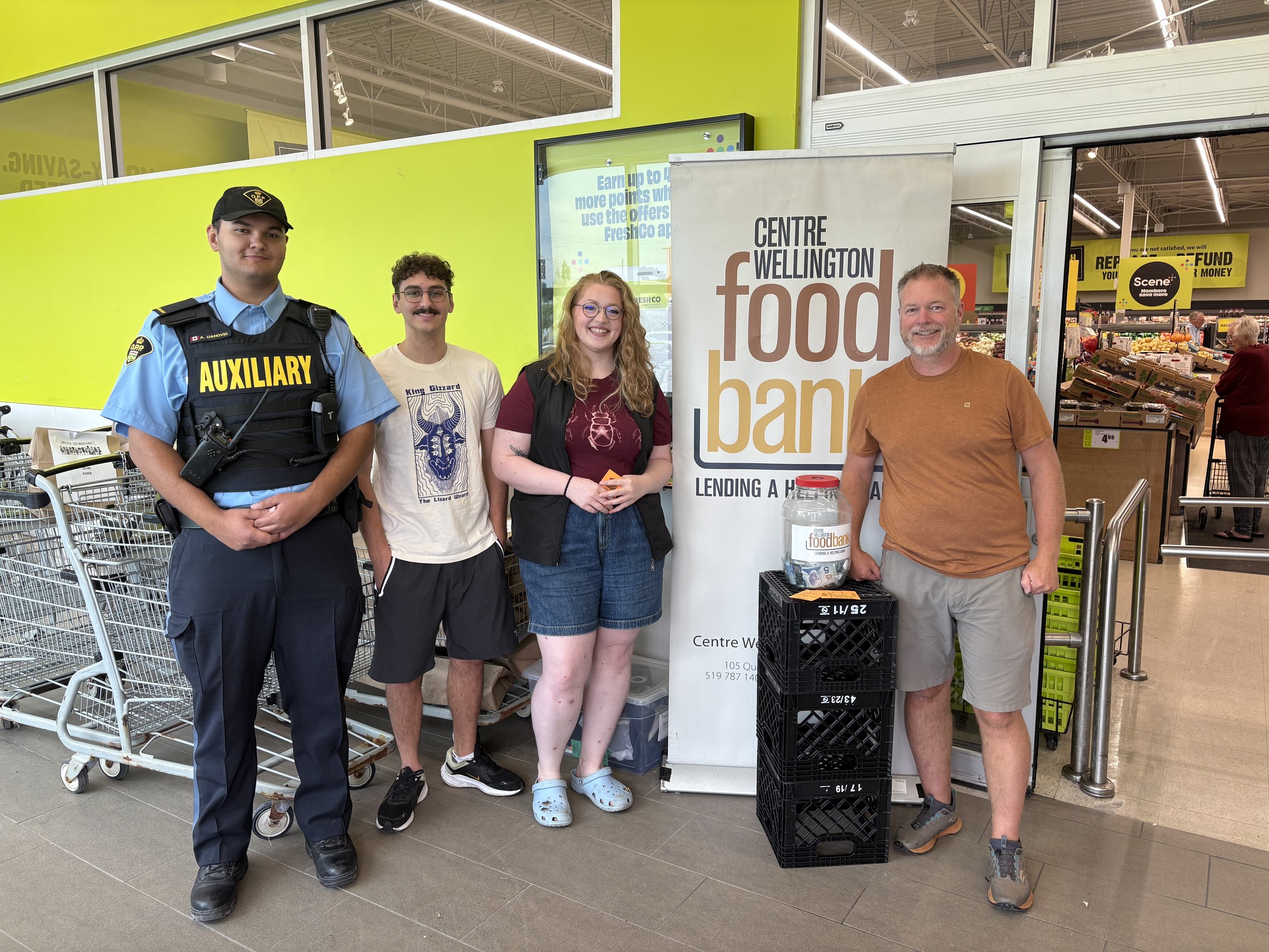 3 adults at a food drive at a grocery store