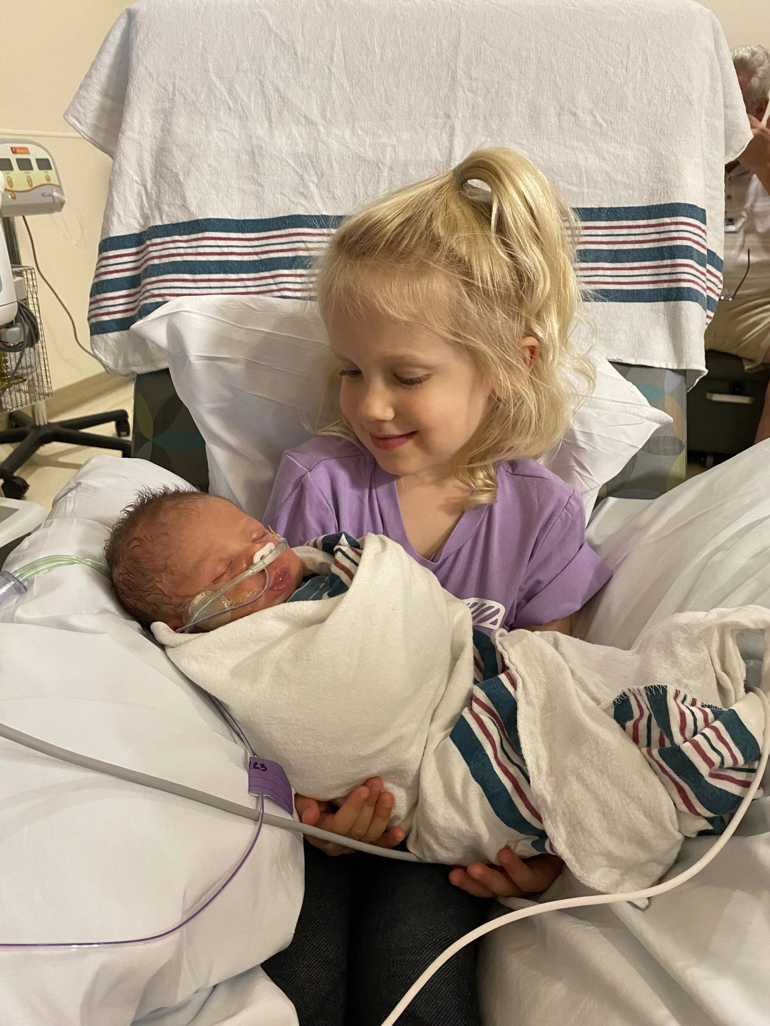 Liam meeting big sister #1 for the first time.