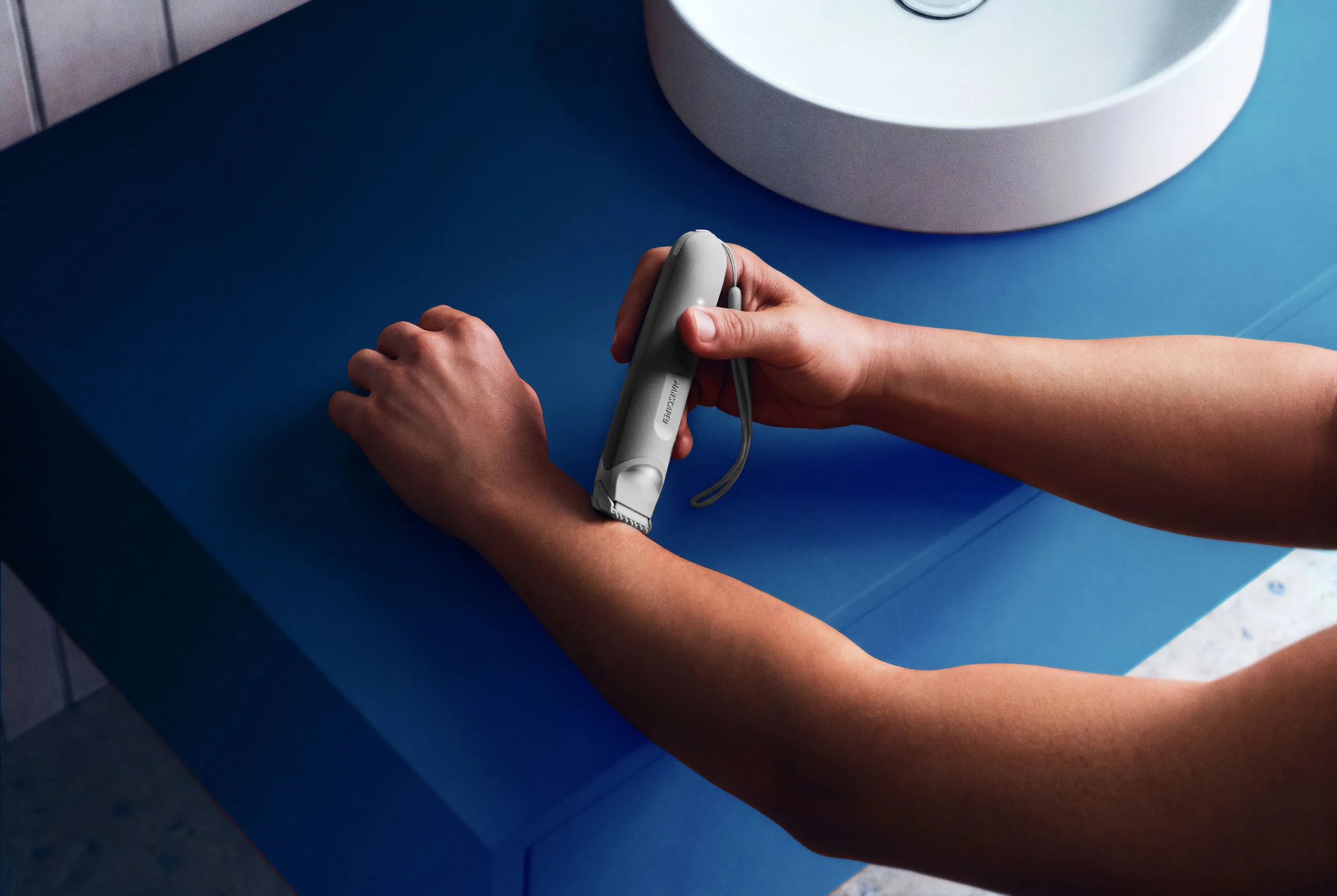 The-Lawn-Mower-GO-shaving-a-man's-arm-Gray-Retail_AG copy.jpg
