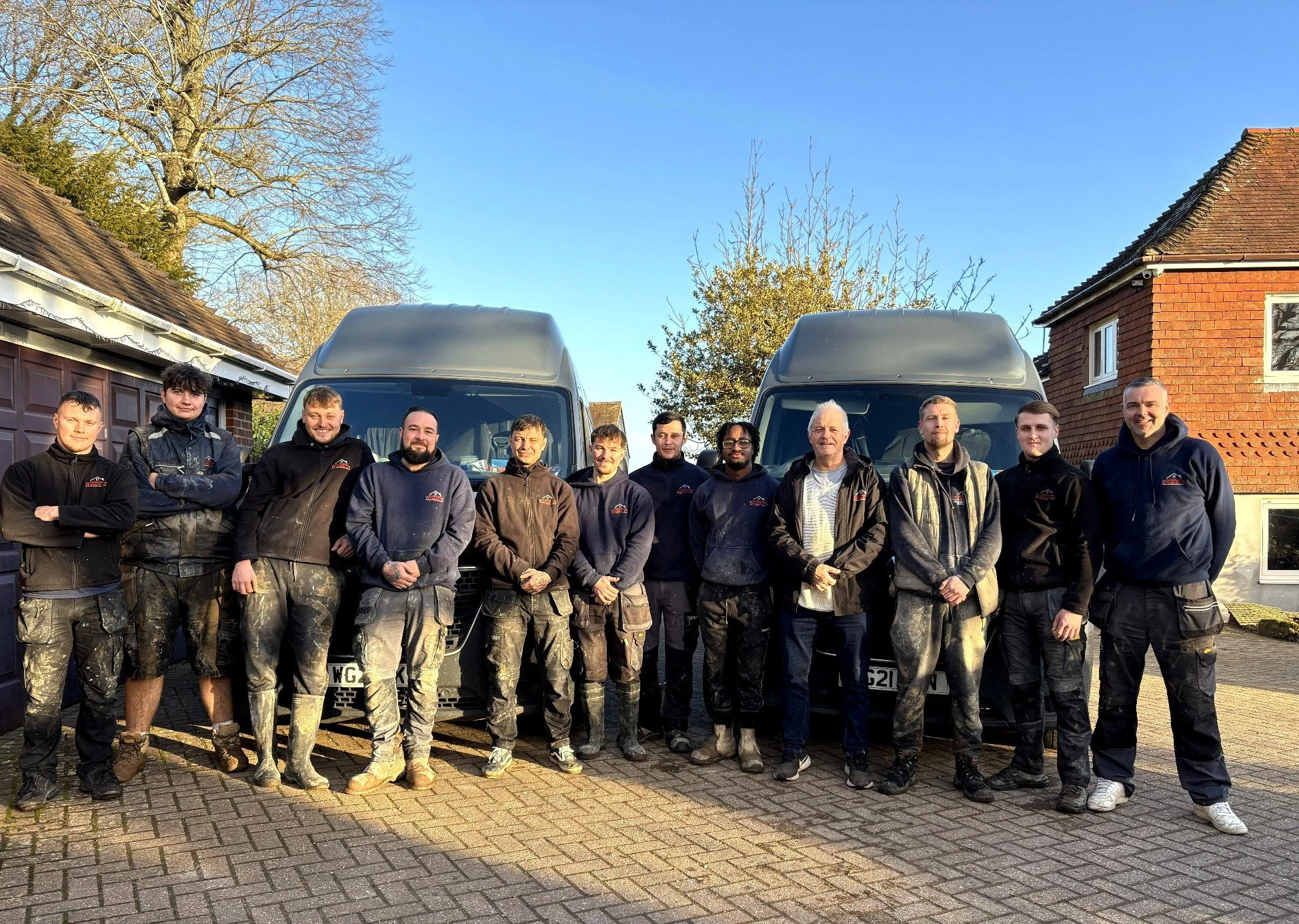 The Canning Ericsson Ltd building team standing in front of company vans on site in Sussex