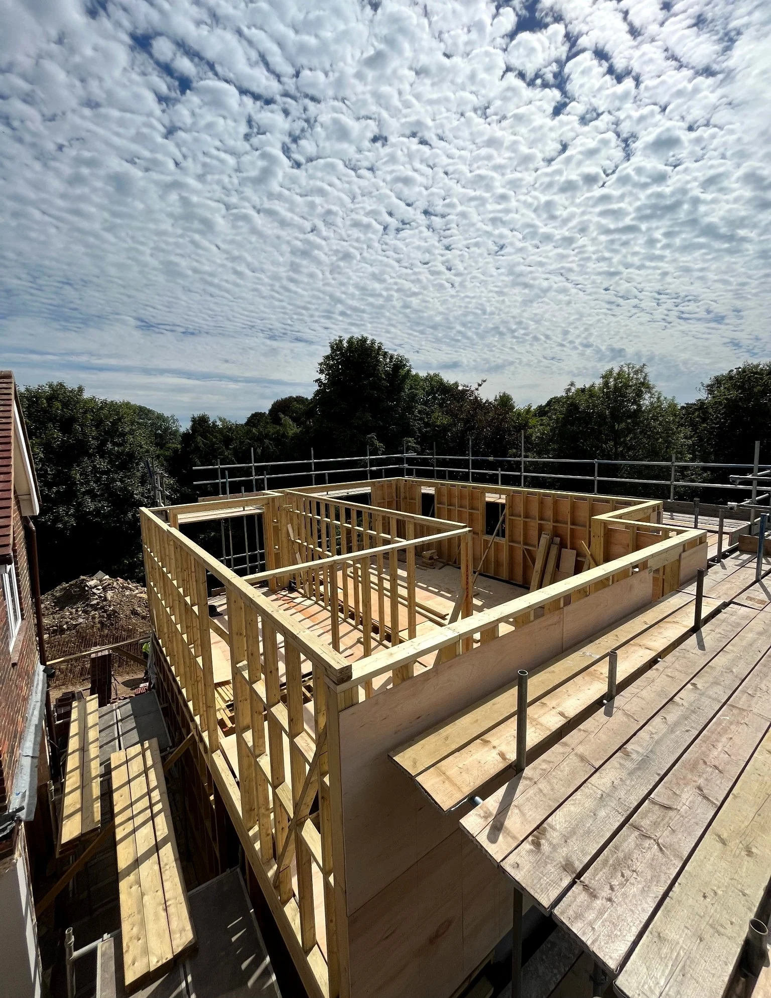 Timber frame structure during early construction phase of the Barcombe new build, viewed from scaffolding.