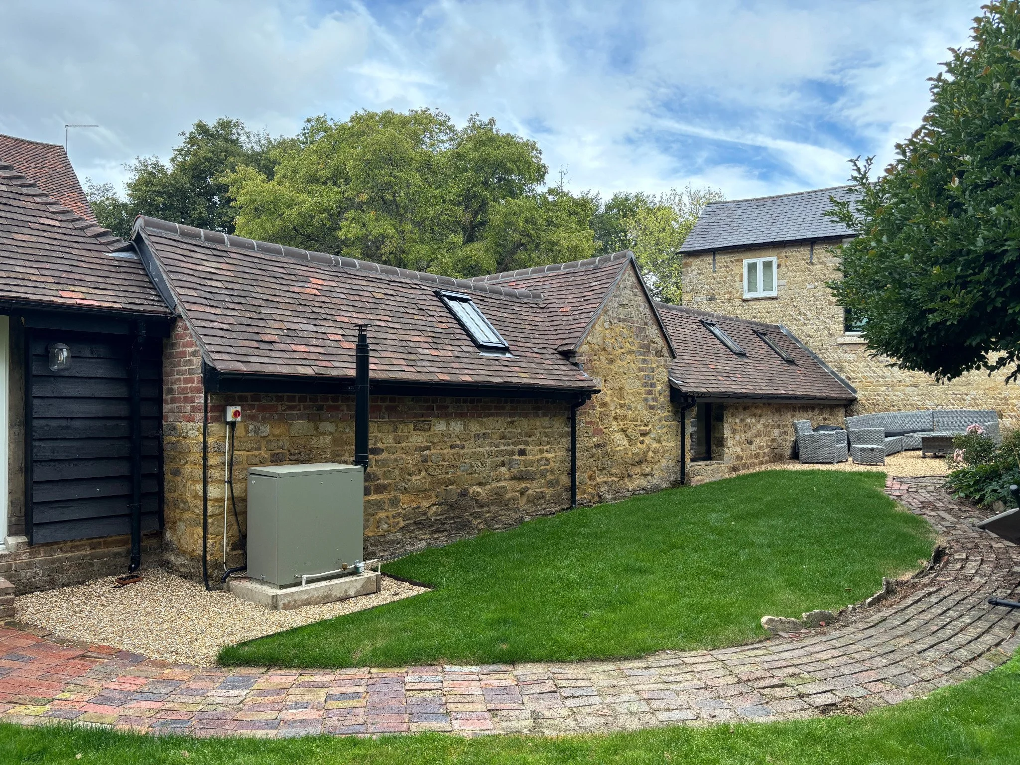 Exterior elevation of a converted barn in Warninglid with landscaped garden.