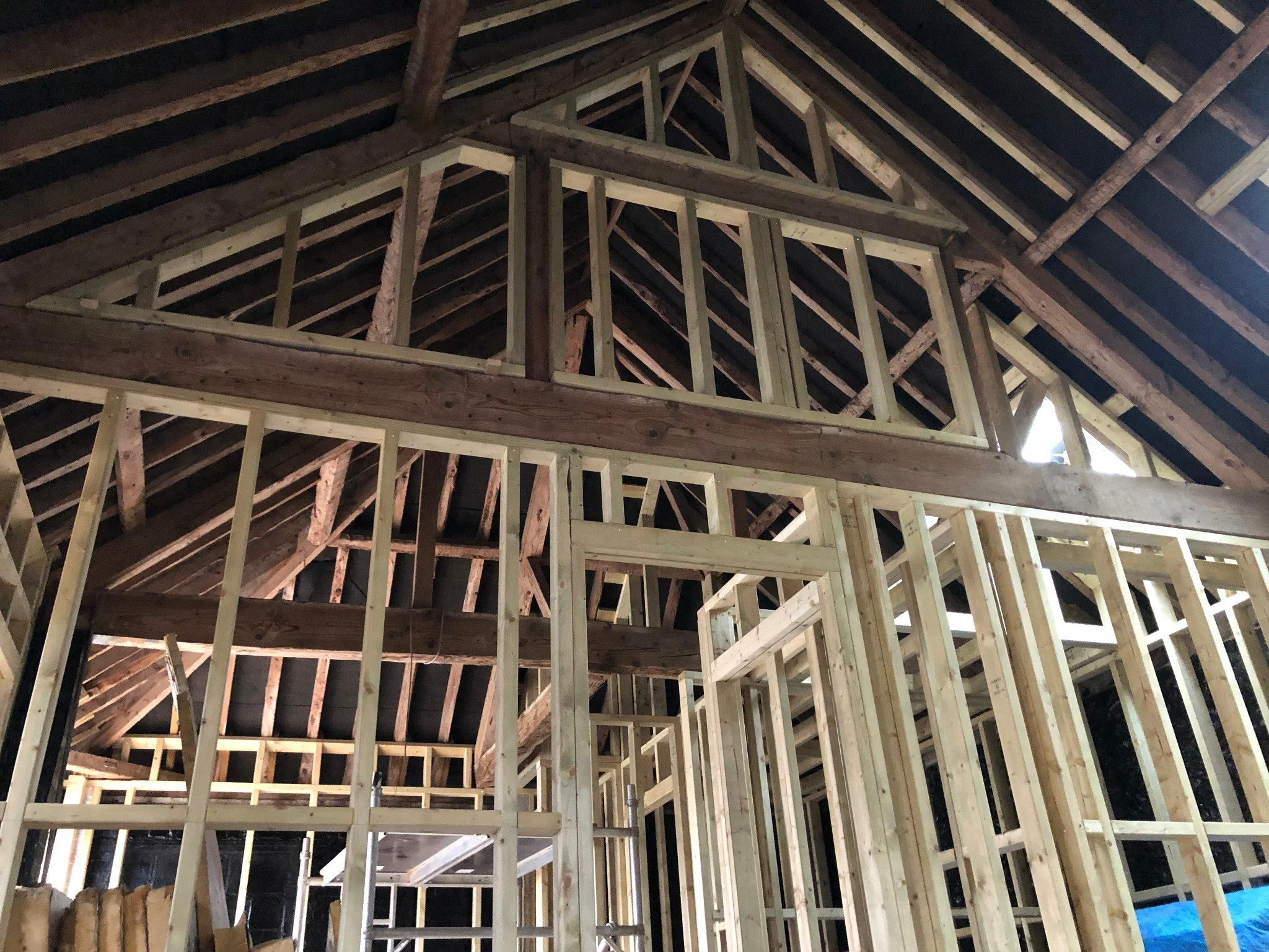 Interior timber framing showing detailed structural carpentry work.