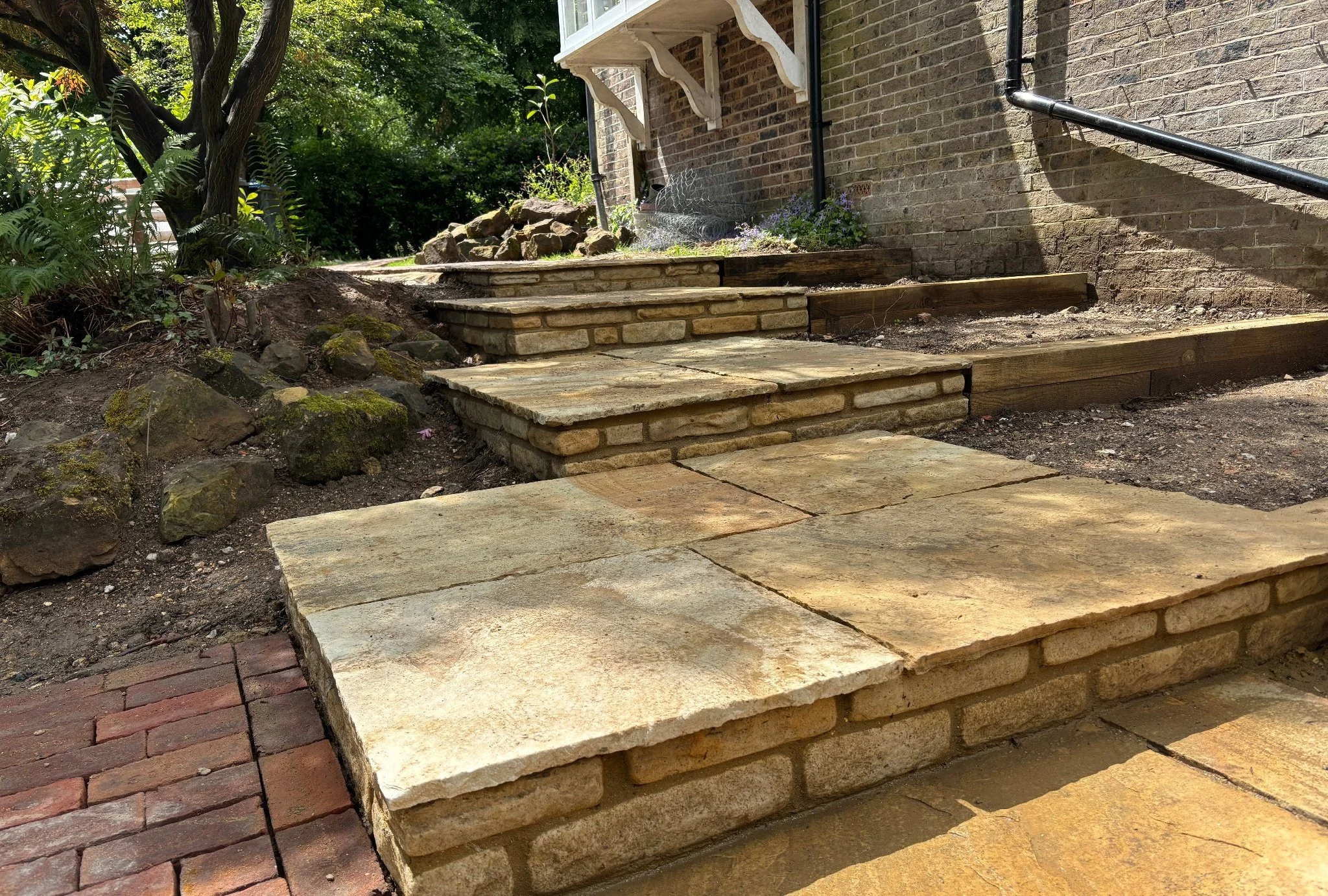Stone steps and retaining wall detail forming part of the landscaping works at a property in Lindfield, West Sussex.