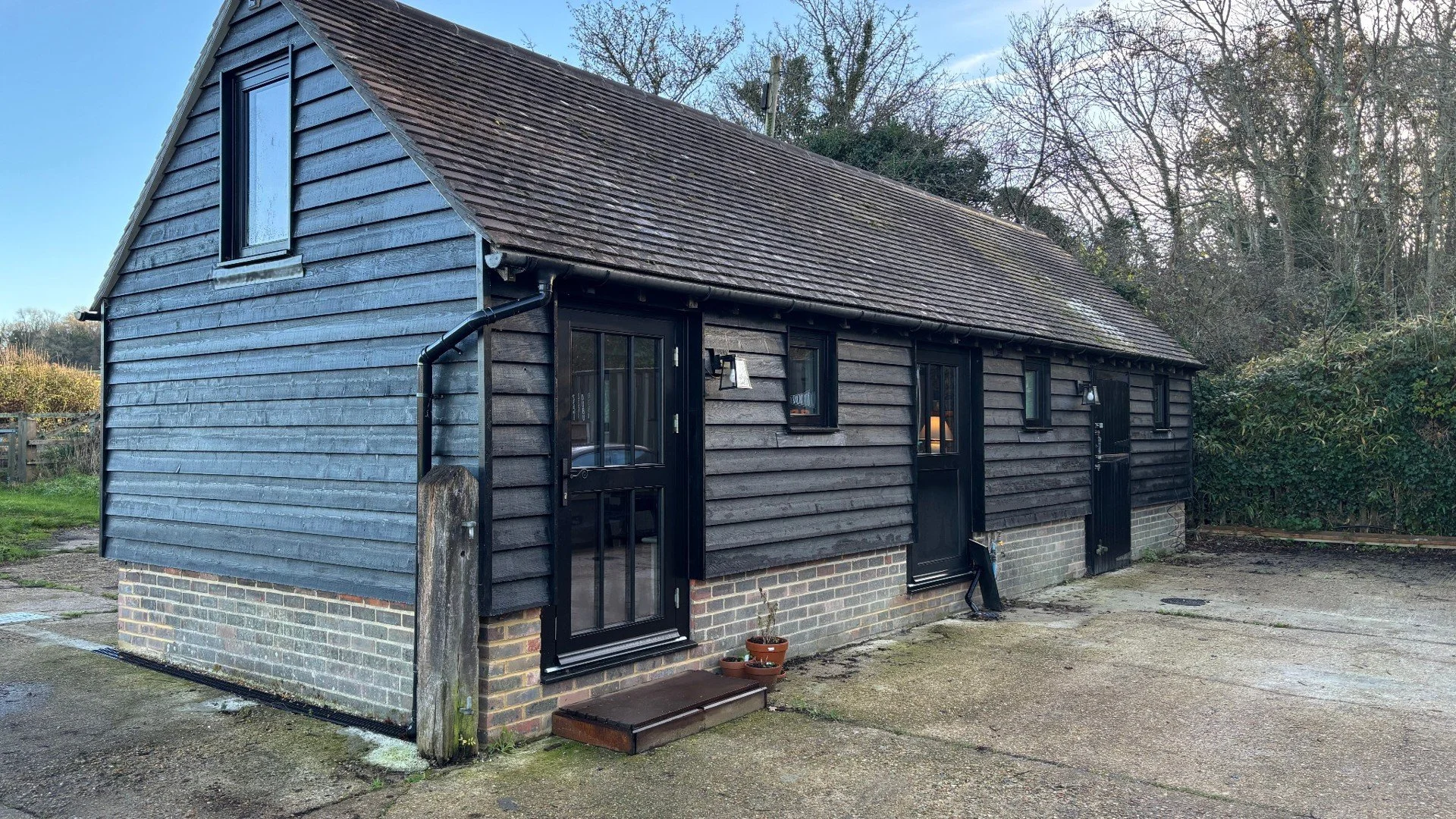 Timber-clad outbuilding converted as part of a Design and Build project in Sussex