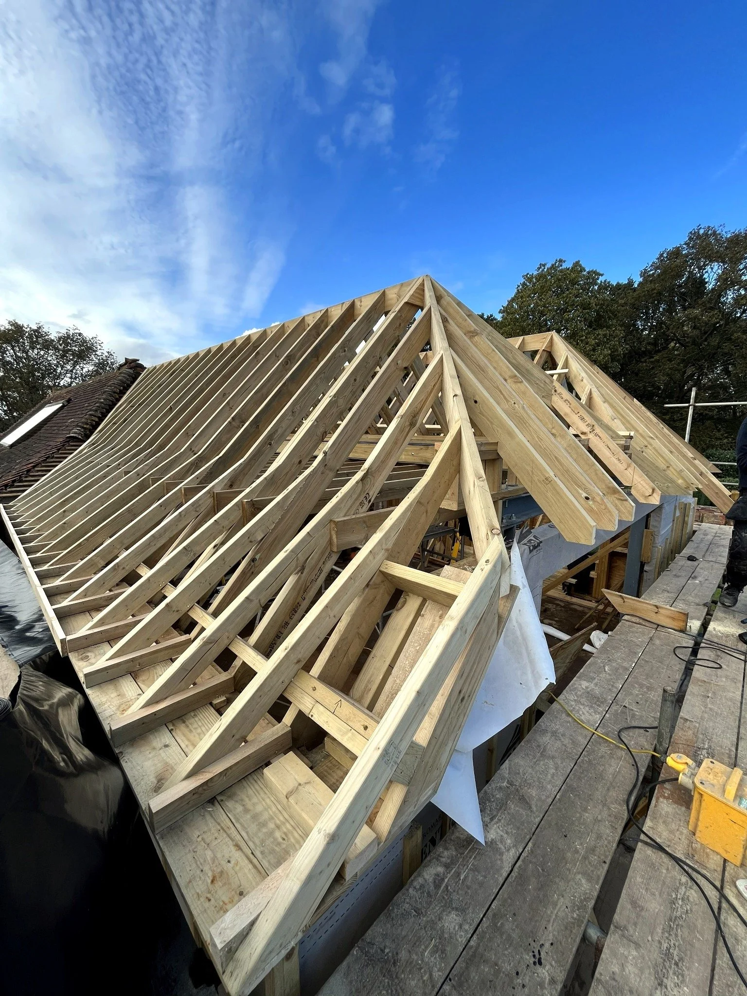 Timber roof structure under construction during an extension project in Henfield, West Sussex