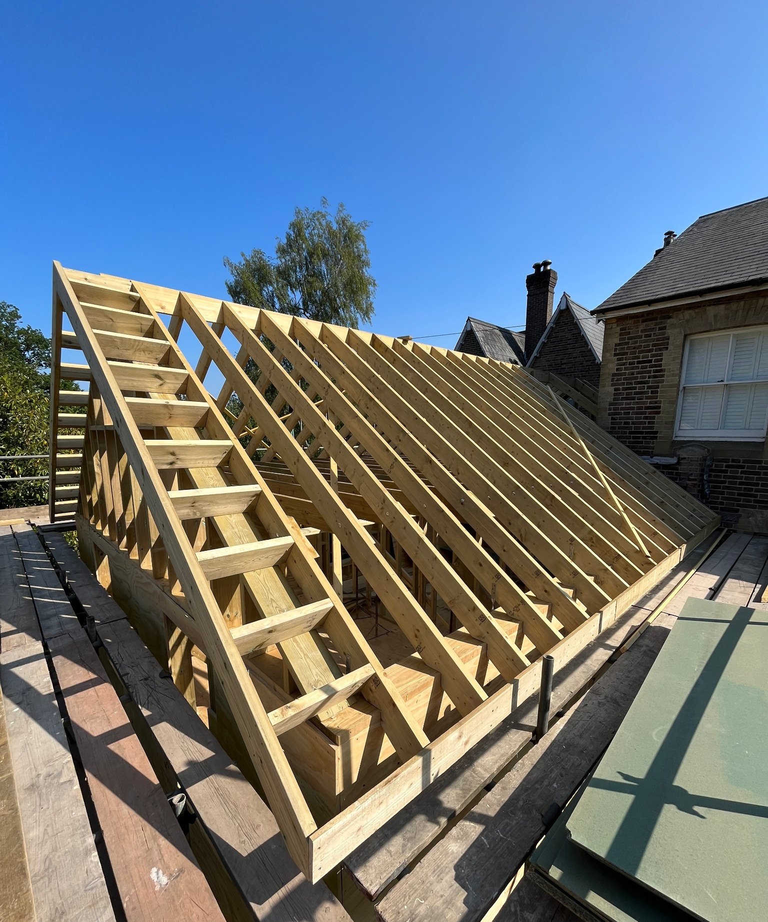 Timber roof structure under construction at a property in Lindfield, showing detailed joinery and framing work.