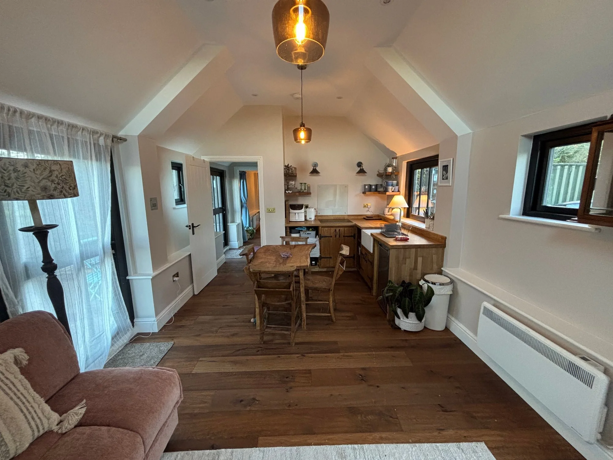 Hurstpierpoint barn conversion interior with open-plan kitchen and dining area, bespoke cabinetry and timber flooring by Sussex builders Canning Ericsson.