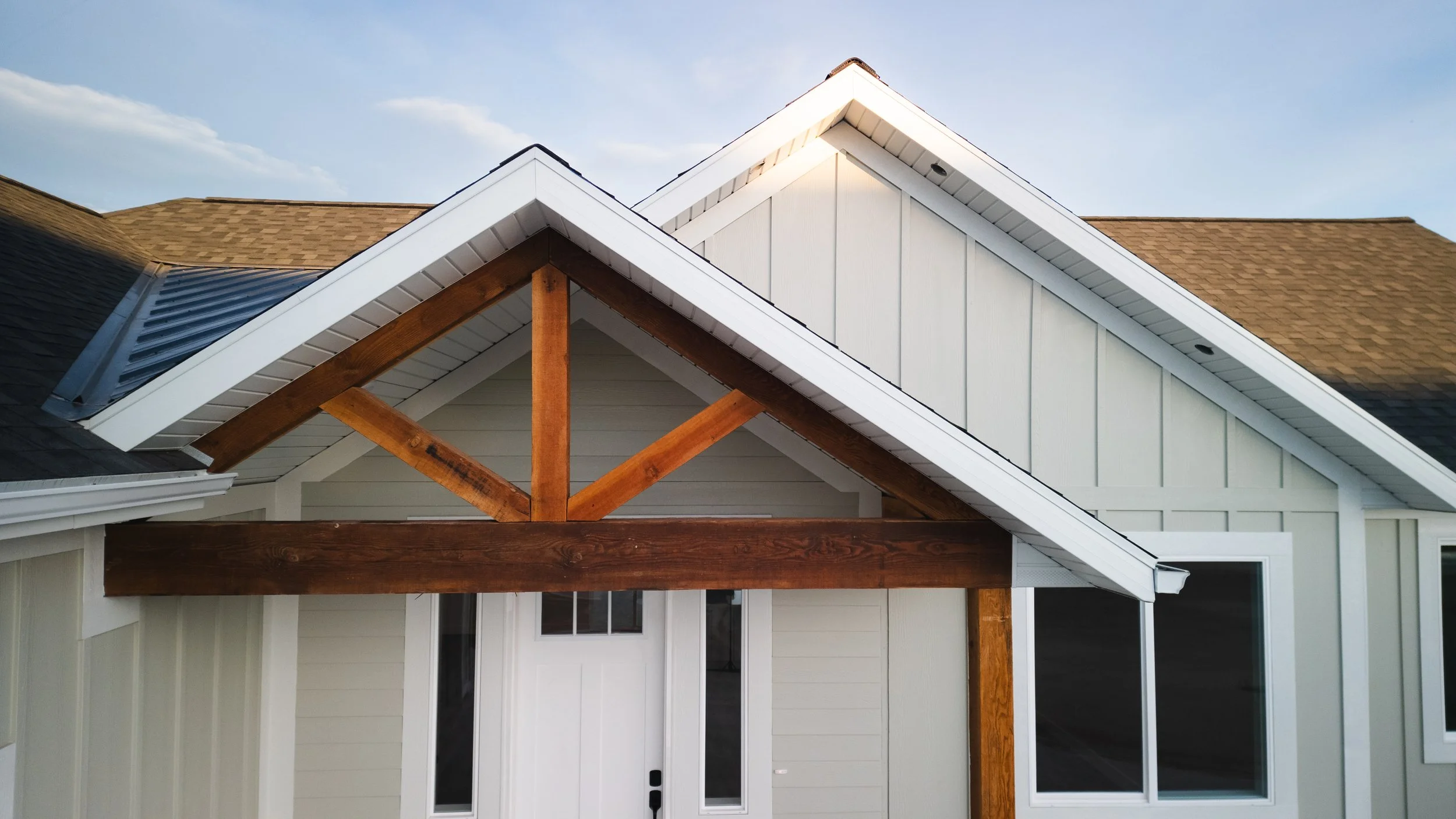 Drone real estate photograph close-up of a house's gabled roof with wood beams and siding. Real estate drone photography and videography services in Roosevelt, Vernal, Uintah Basin, Utah, and nationwide.