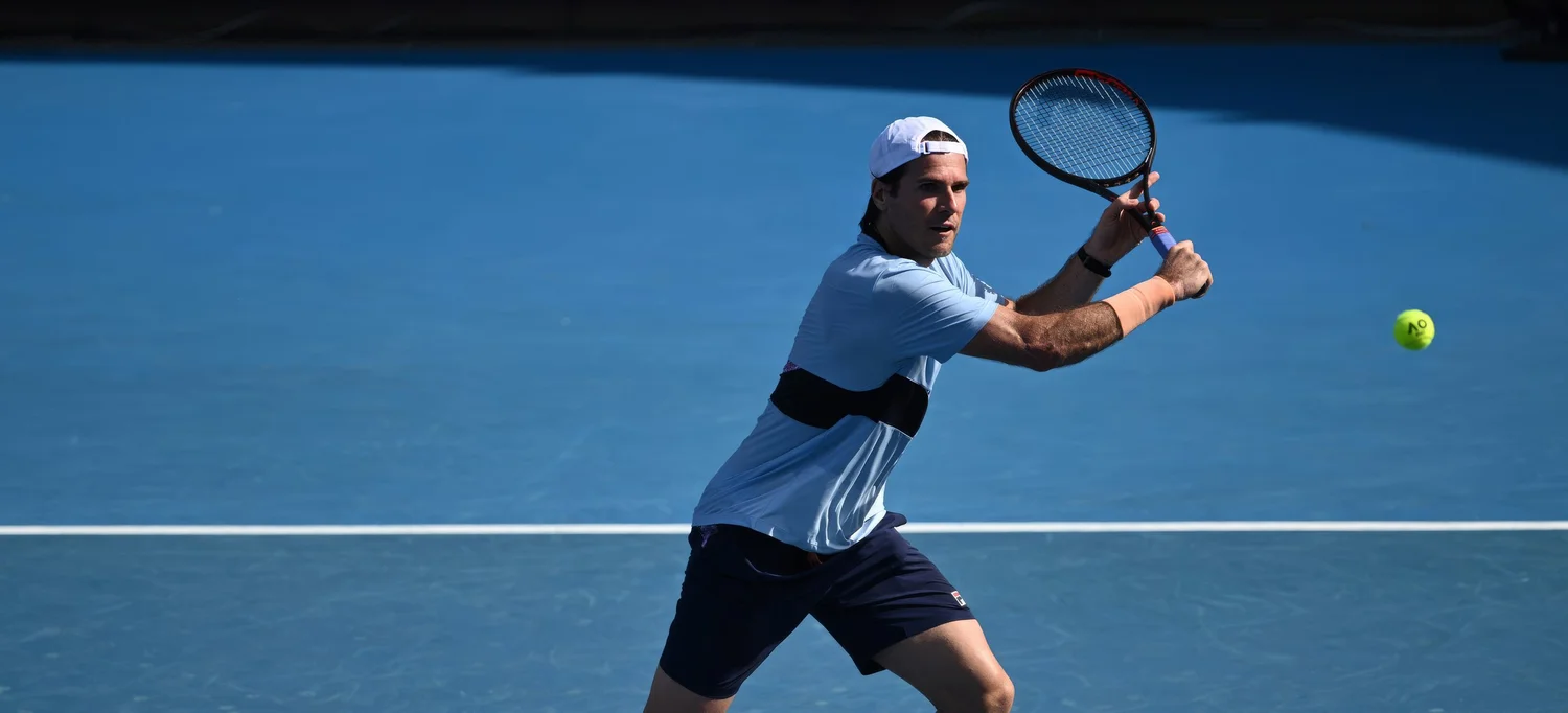 Tommy Haas preparing to hit a forehand on a blue hard court