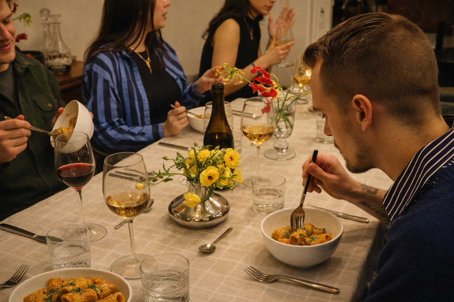 Dinner party with pasta and wine.png
