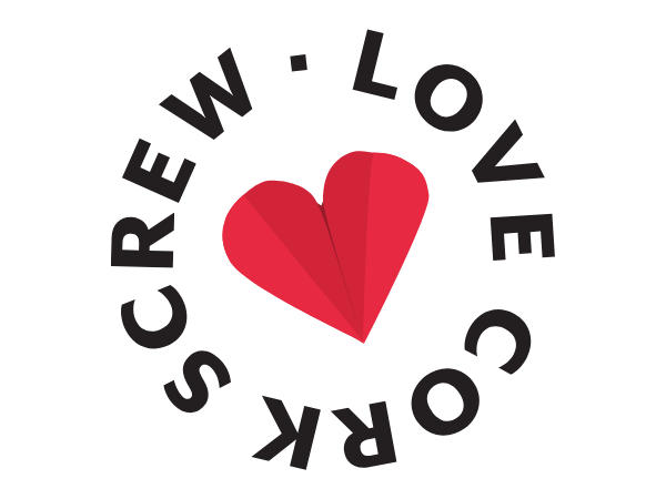 A red, folded paper heart with black text around it that says 'Love. L O V E C O R E W' in a circular pattern.