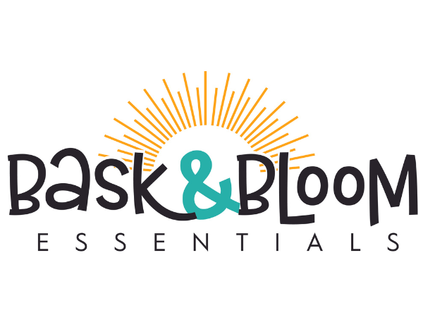 Logo for Bask & Bloom Essentials with a stylized sun above the text.