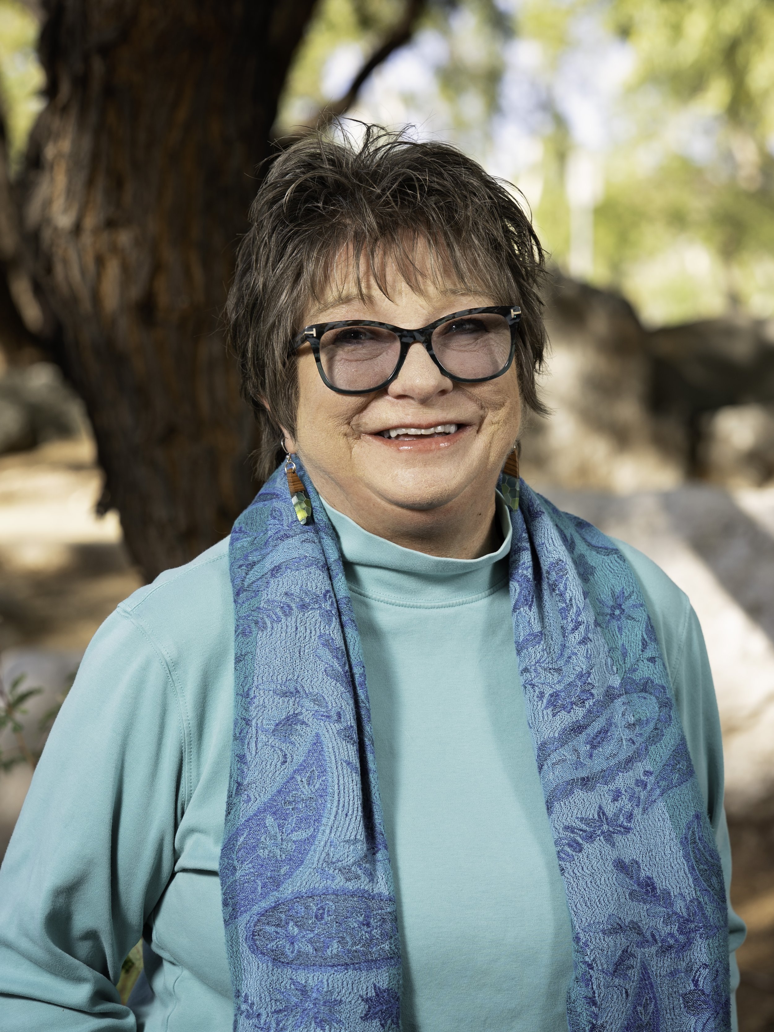 Counselor in front of a tree