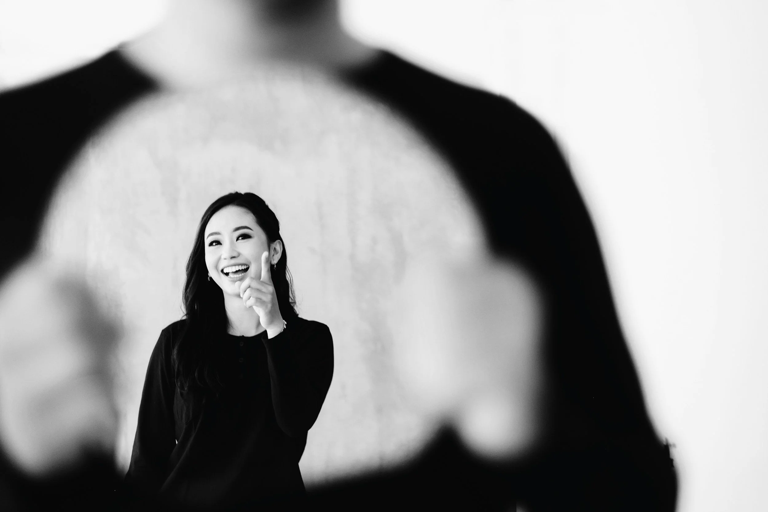 Black and white image of a woman laughing freely representing joy and emotional freedom through therapy