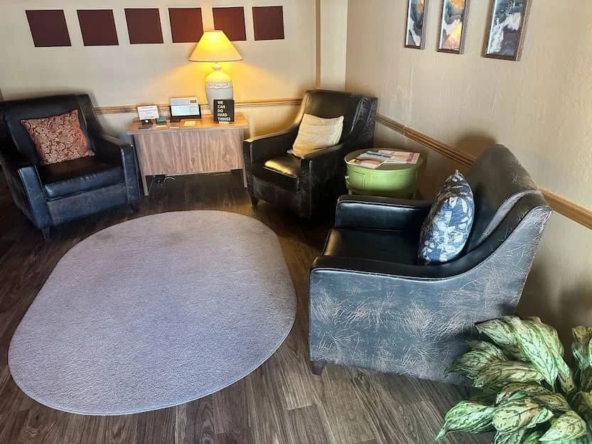 Welcoming therapy office waiting area with armchairs and warm lamp light for trauma therapy in Phoenix AZ