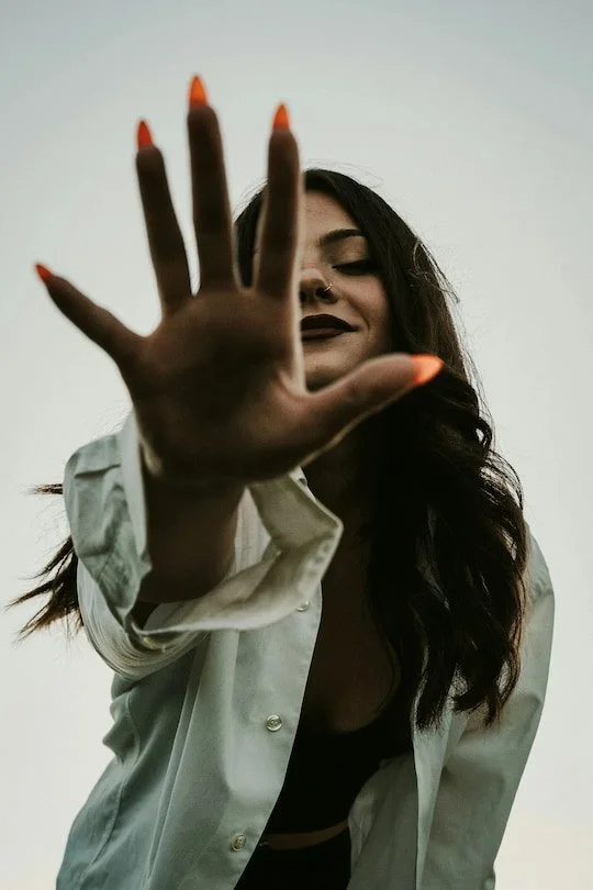 Woman extending her hand toward the camera