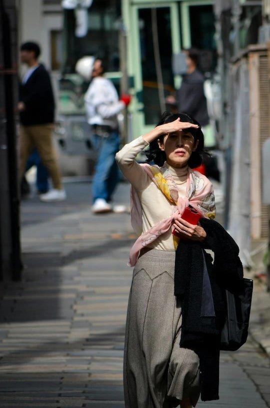 Woman walking alone on a city street during the day