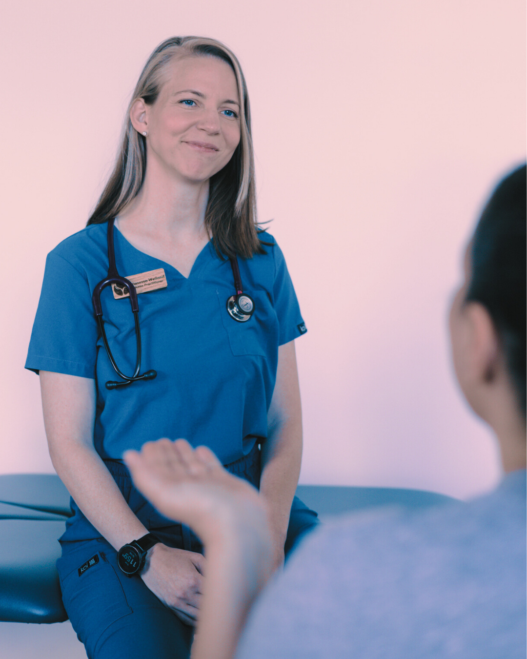 image of Vanessa in her clinic talking to a patient