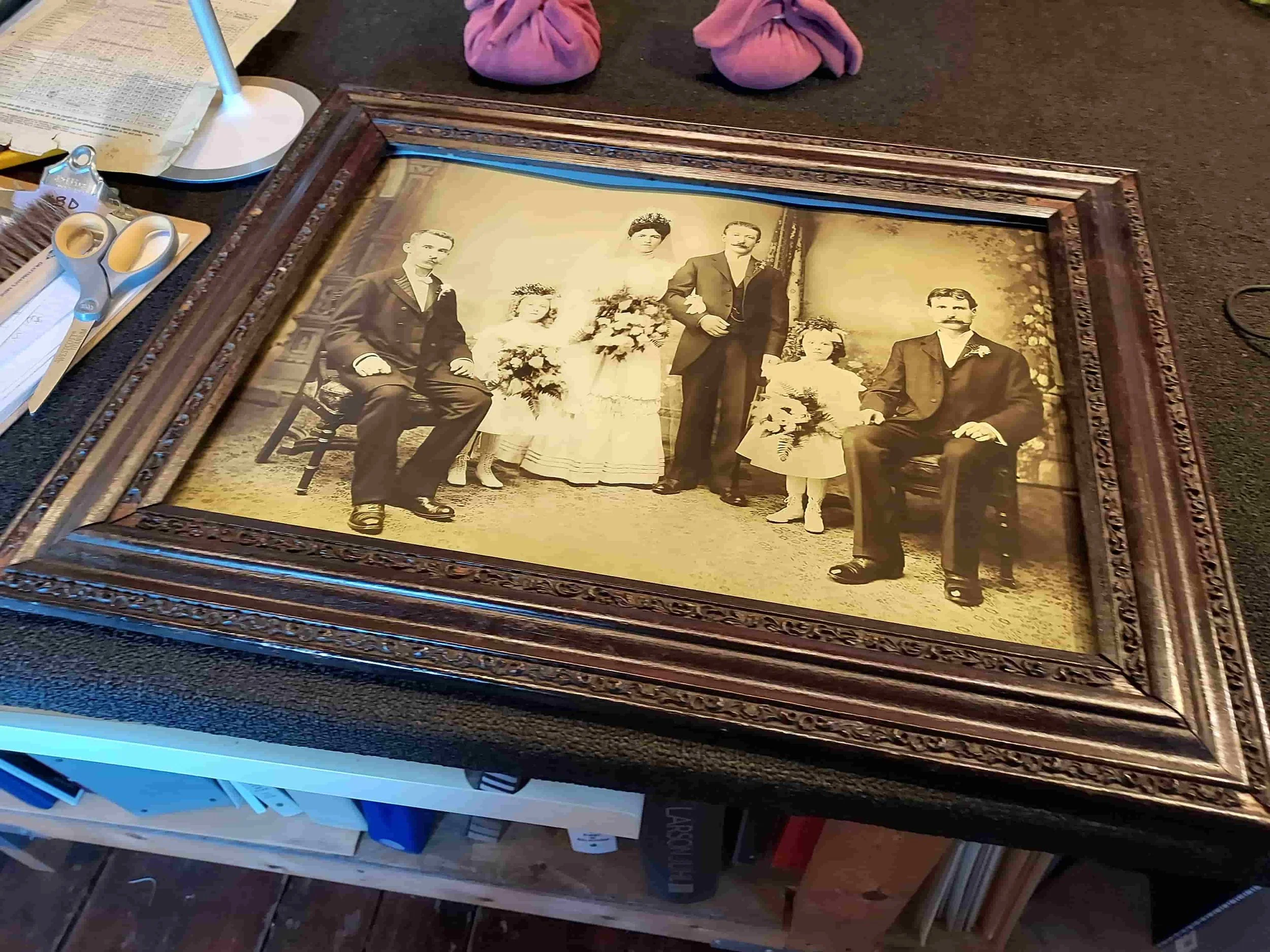 Newburgh Mercantile-restored antique sepia-toned wedding portrait of six people, set in a dark, ornate custom wood picture frame.