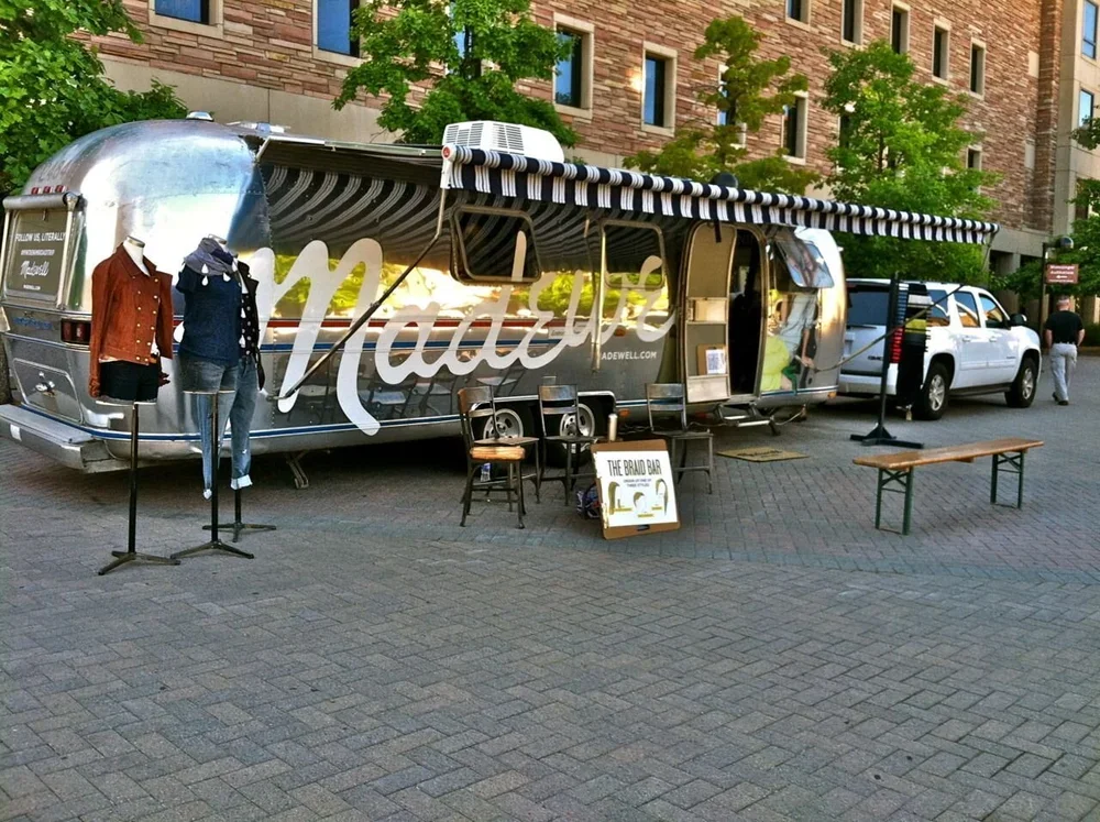 Madewell Airstream pop-up in New York City featuring outdoor seating and branded apparel display.