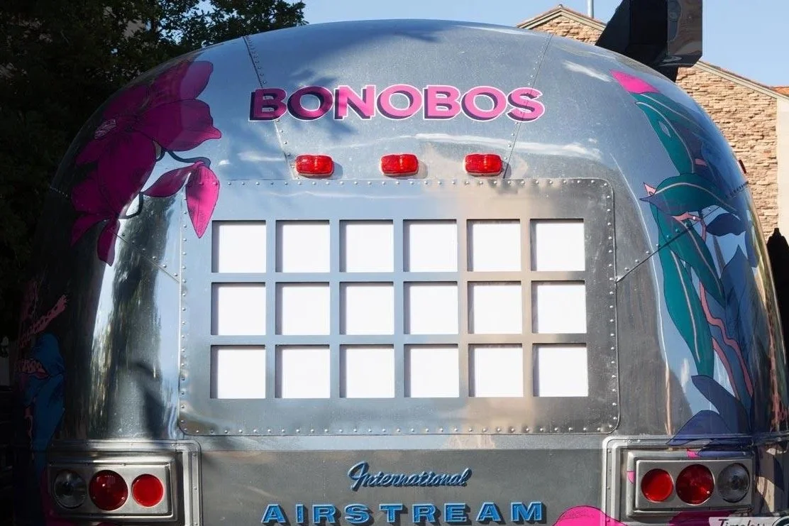 Rear view of the Bonobos Airstream featuring floral artwork and branding for the Bonobos mobile pop-up activation.