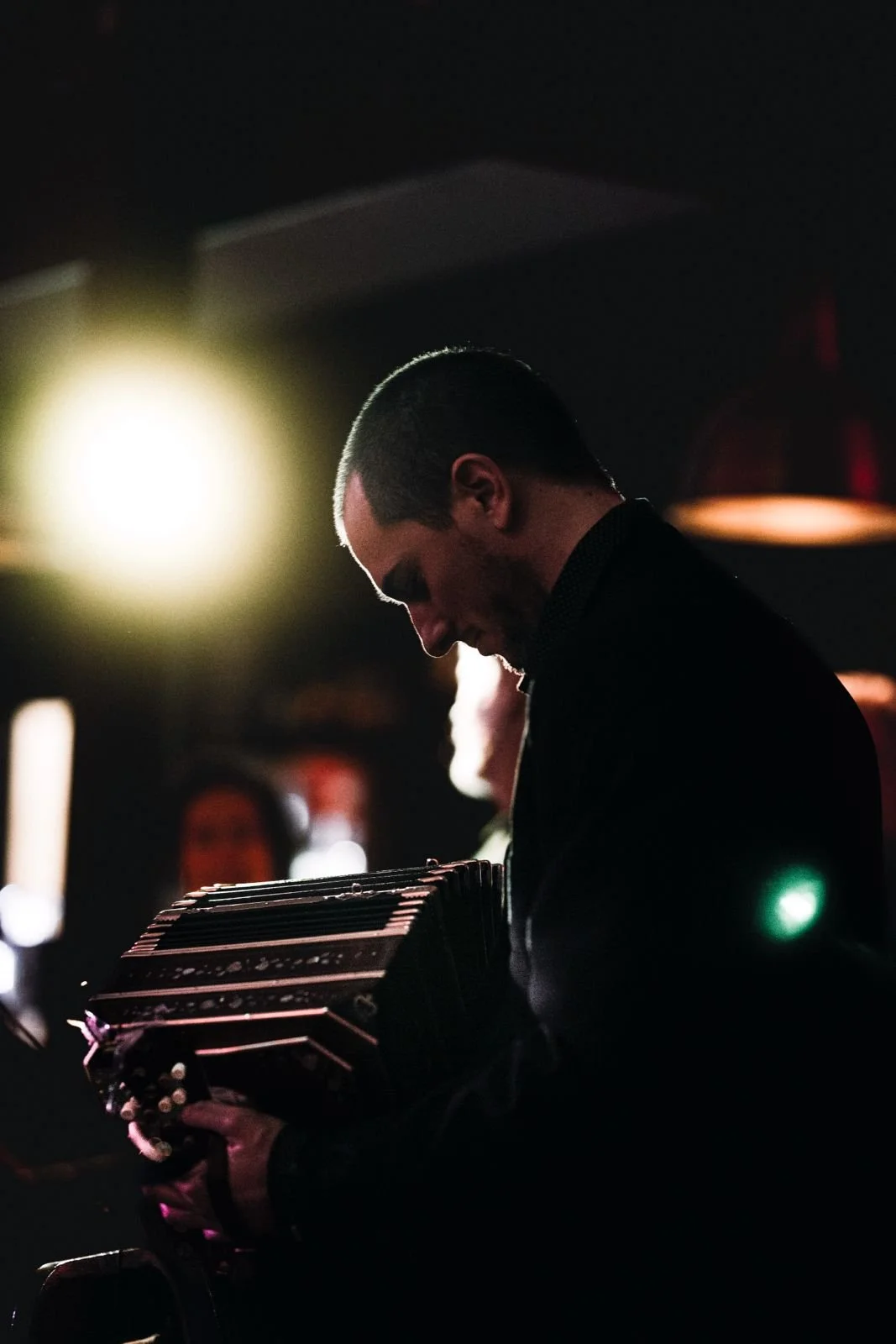 Guillermo Willis is playing Tango music with his instrument, a bandoneon.