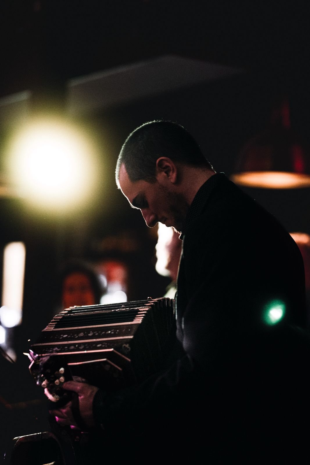 Guillermo Willis is playing Tango music with his instrument, a bandoneon.