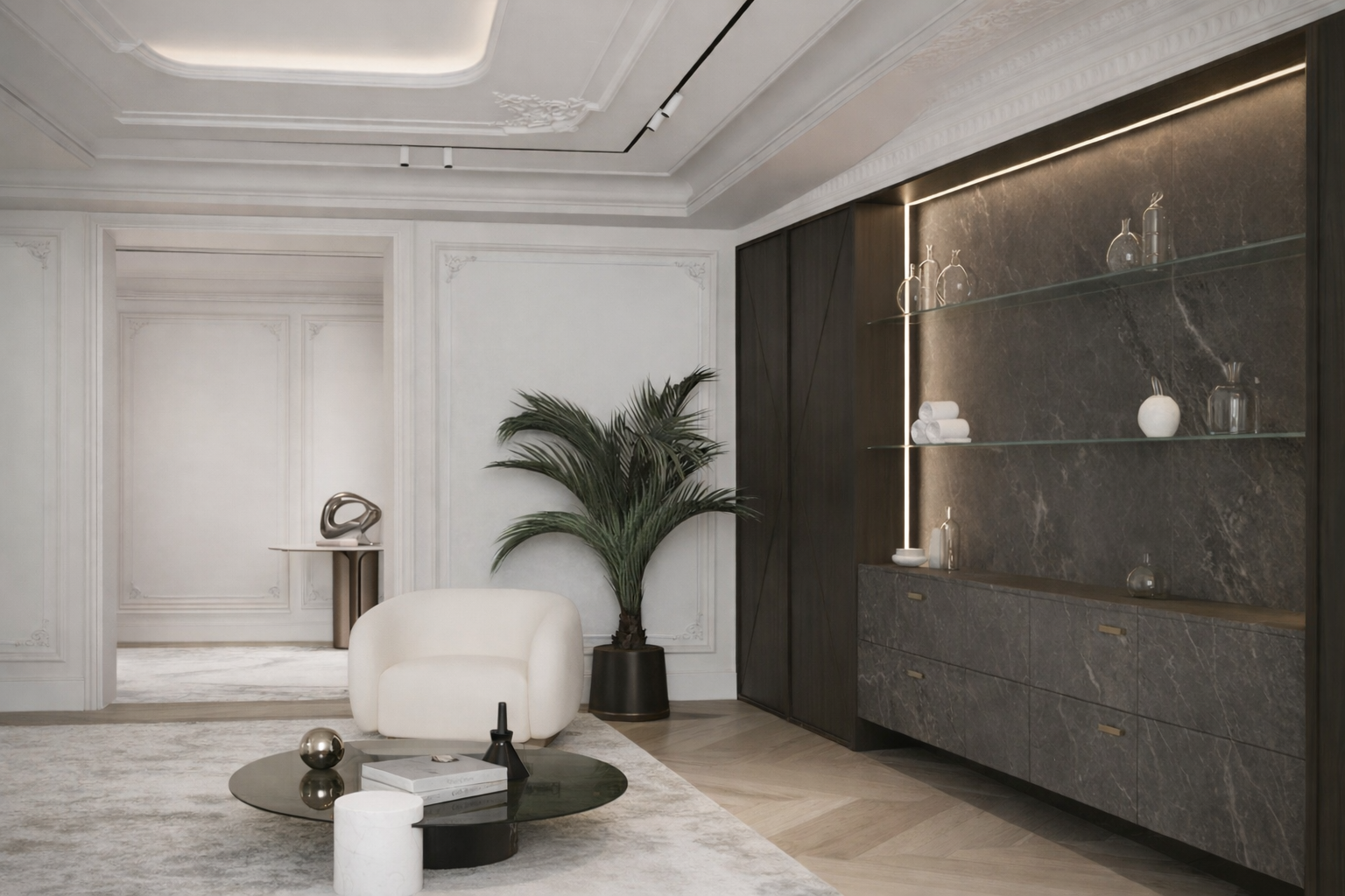 Sala de estar moderna con paredes blancas, sillón blanco, mesa de centro negra, plantas verdes, y una pared decorativa de mármol oscuro con gabinetes.