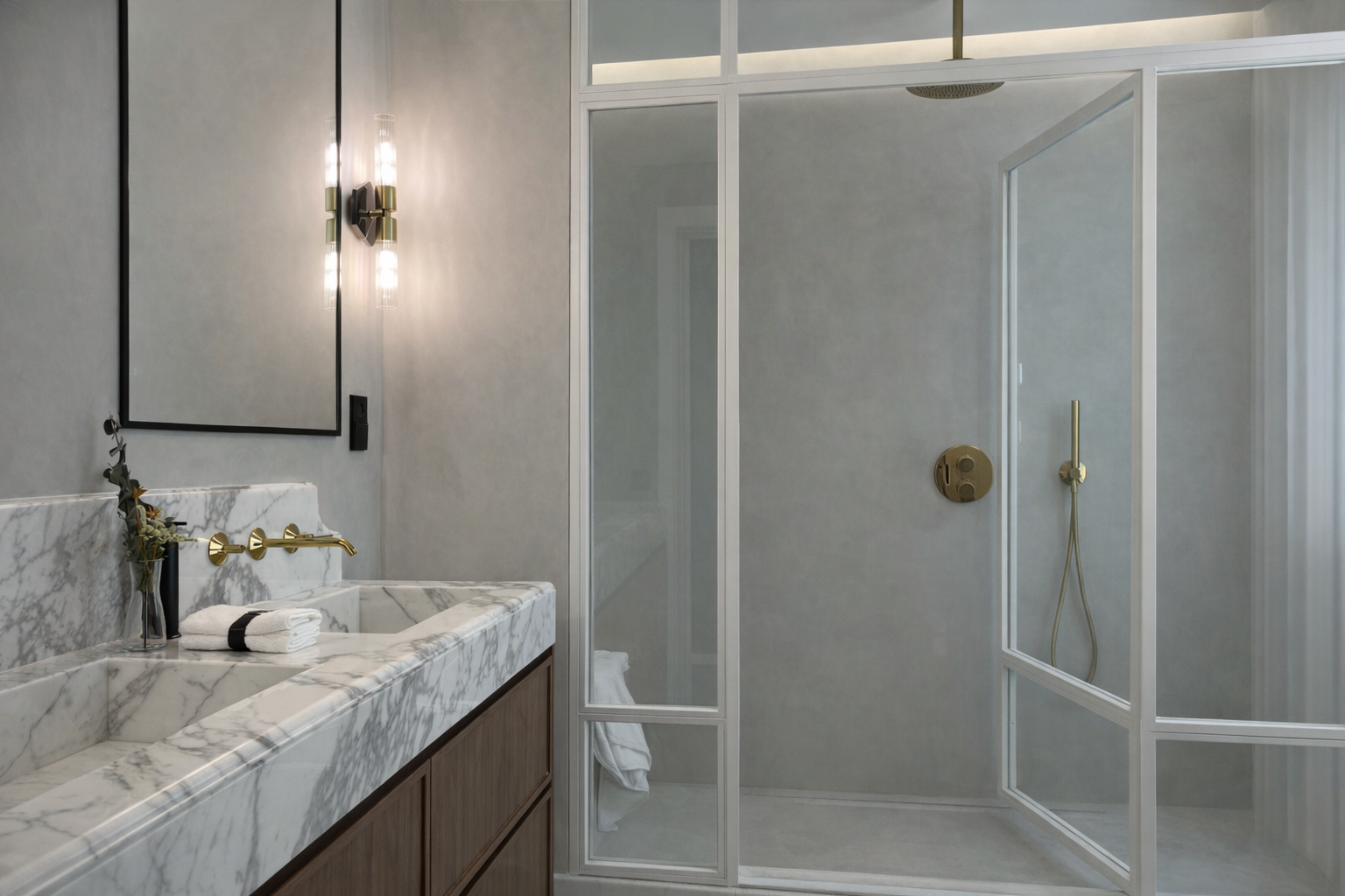 Baño con lavabo de mármol, ducha separada con cristal, paredes blancas y decoración moderna.