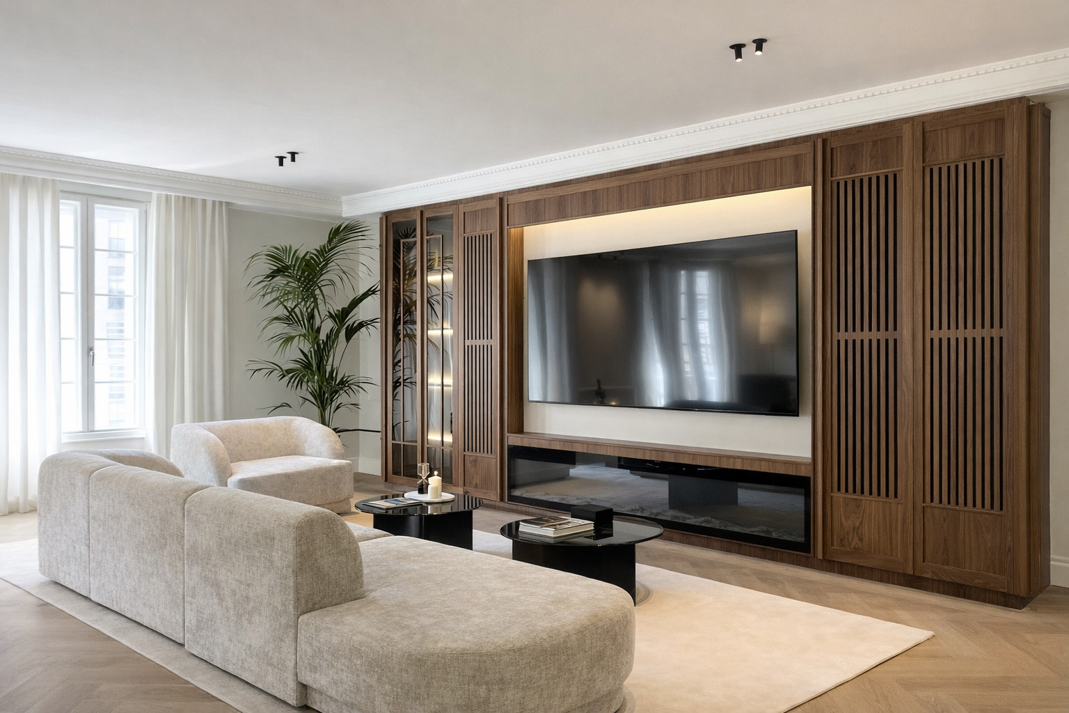 Sala de estar moderna con sillones beige, mesa de centro negra, pared de madera con televisión grande y estanterías, planta de interior junto a la ventana con cortinas blancas.