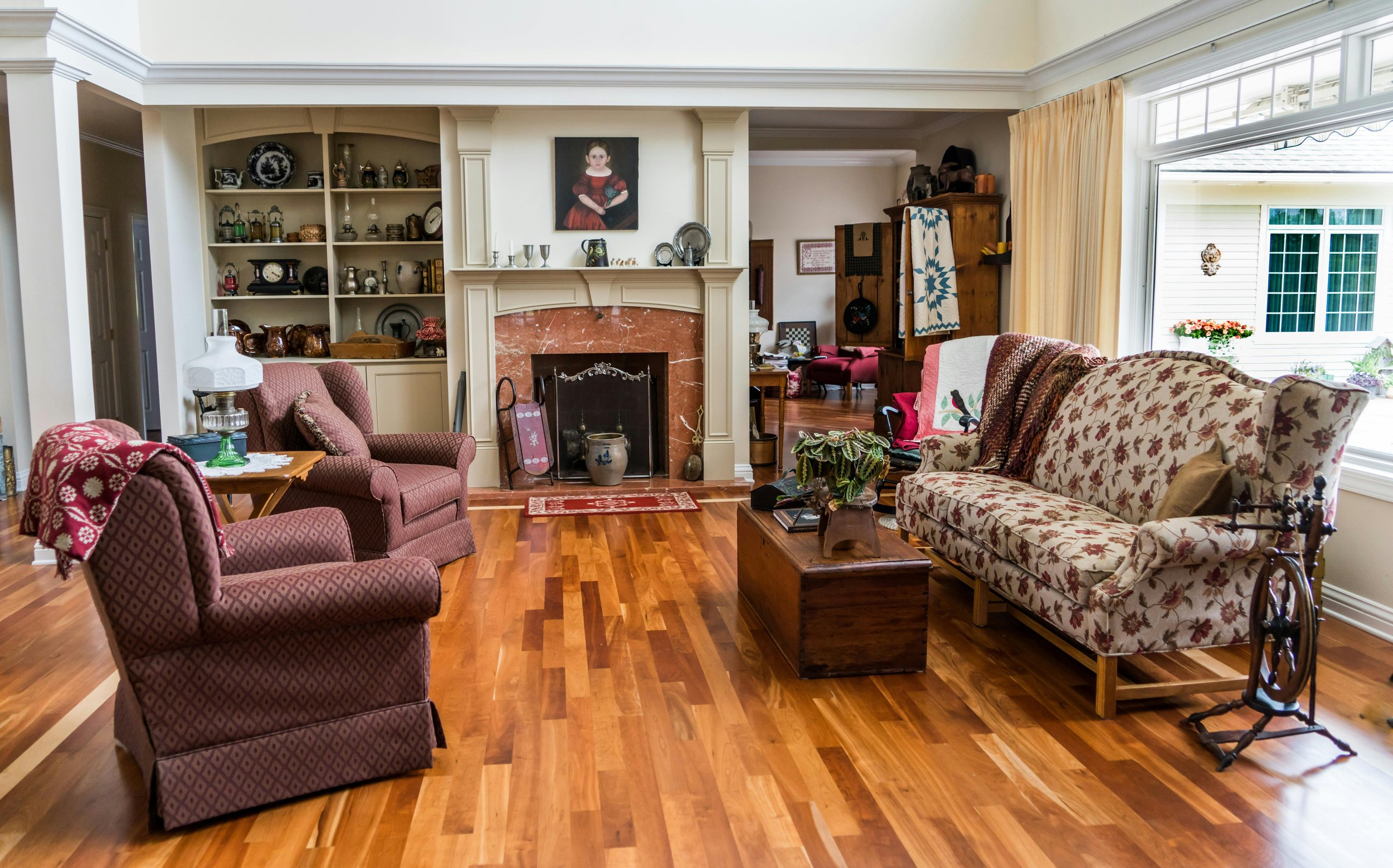 estate home interior during initial walkthrough showing furnished living room with furniture, decor, and household contents before sorting