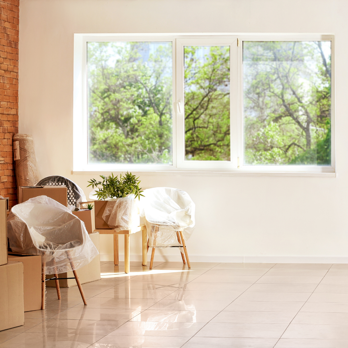 A bright, partially cleared room with minimal furnishings, illustrating a home being prepared for its next stage after a transition.
