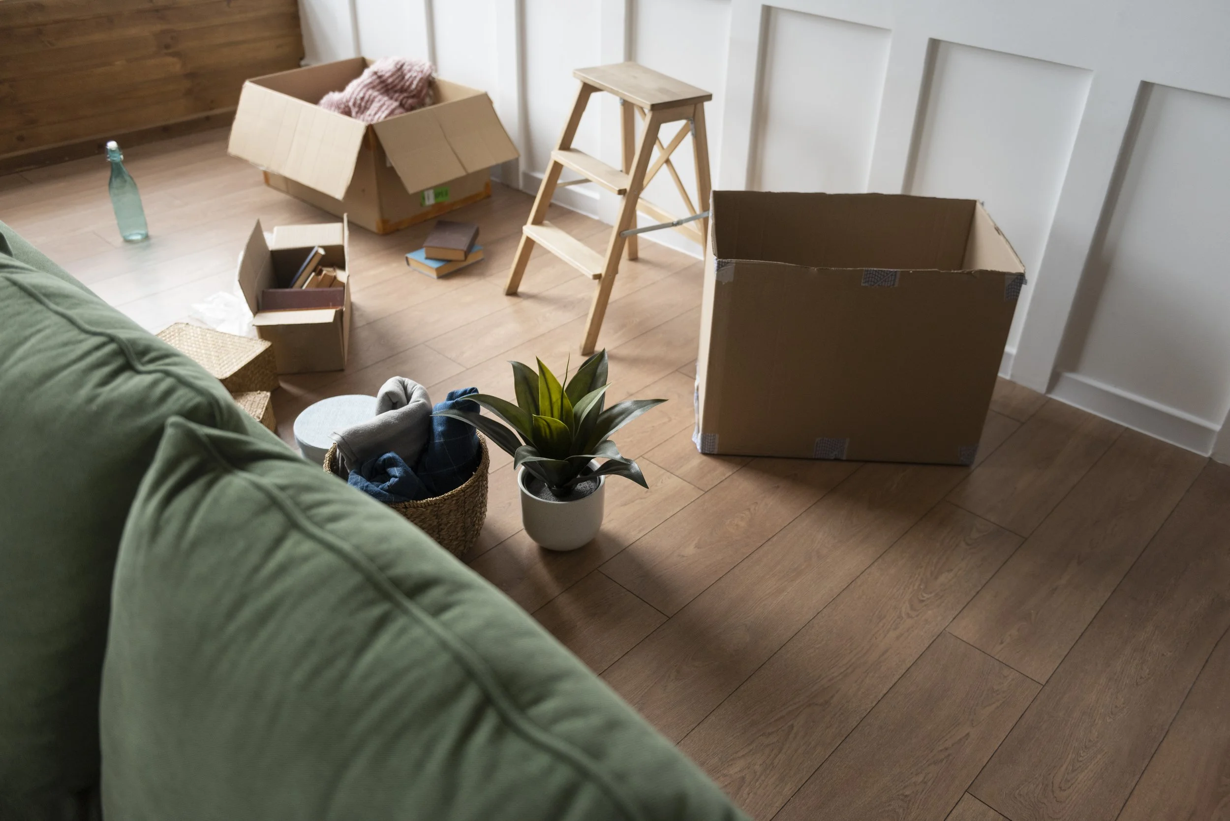 mostly cleared room with boxes and remaining items being packed during final stage of estate clear out and home preparation