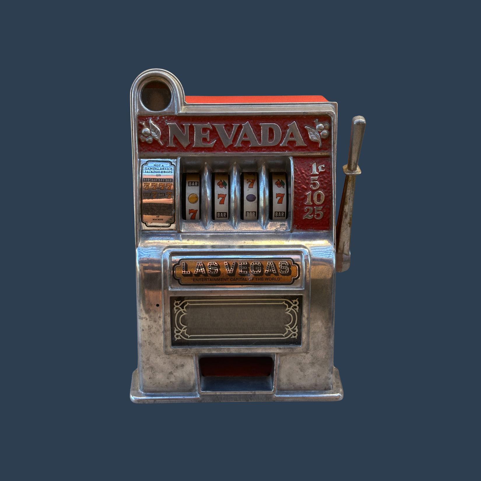Vintage Nevada slot machine for sale, with metallic finish, red and silver colors, and 'Las Vegas' label, against a dark background fo