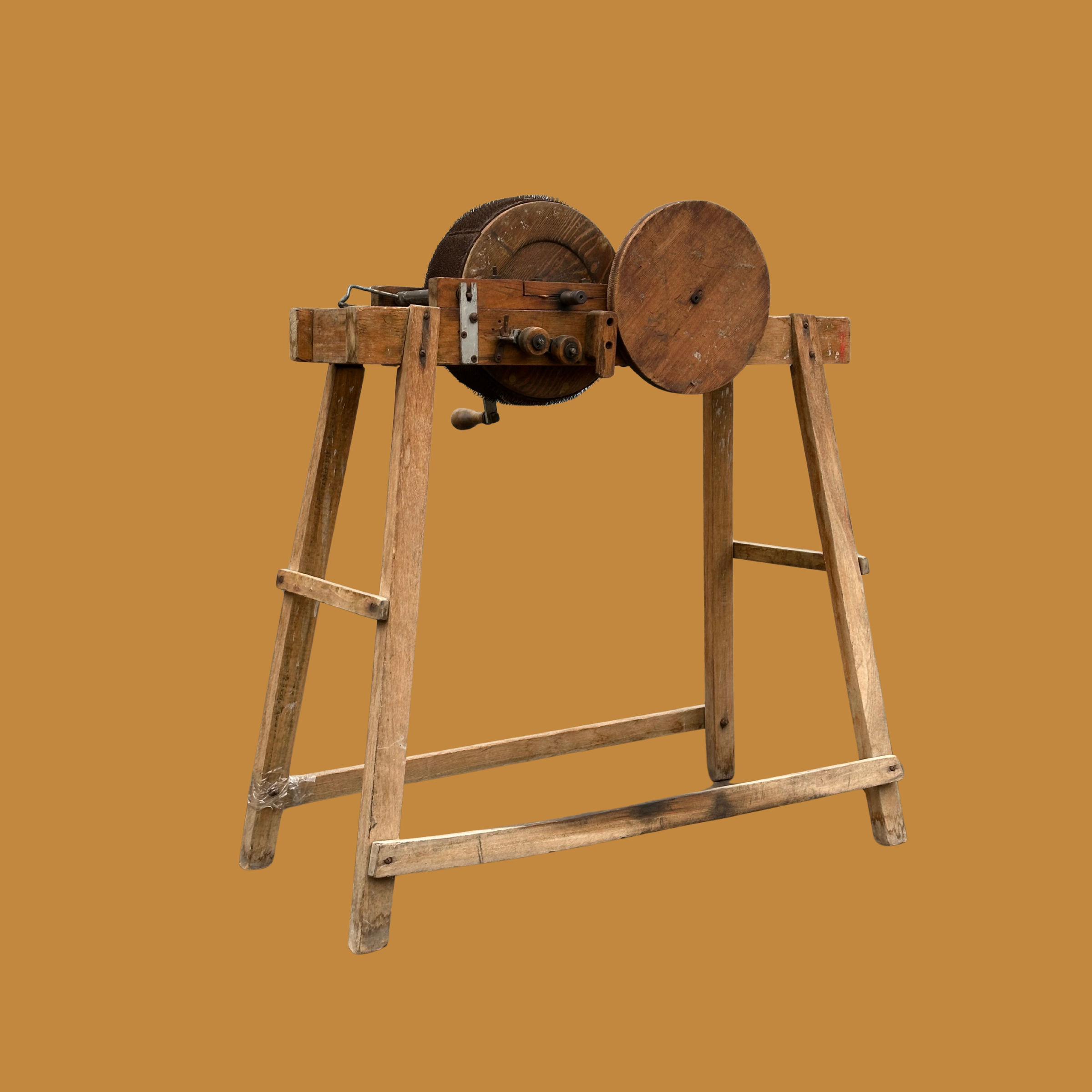 An old-fashioned woodworking bandsaw for sale with a wooden frame and circular blade, set against a plain brown background.