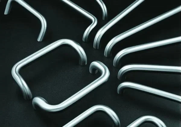 A collection of metal hooks arranged on a black surface.