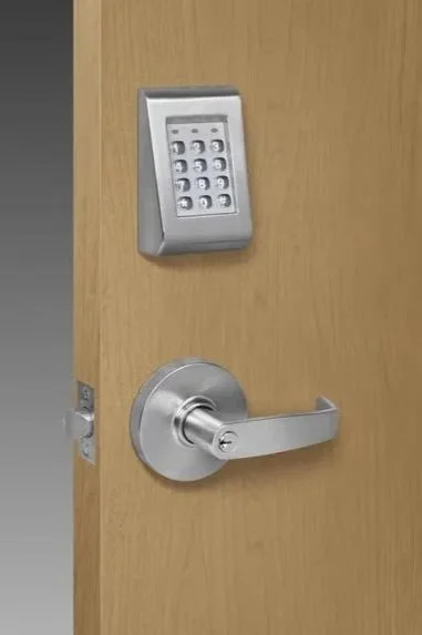 A wooden door with a keypad lock and a silver door handle.