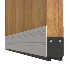 Close-up of a wooden door with a gray metal bottom panel and a black rubber seal.