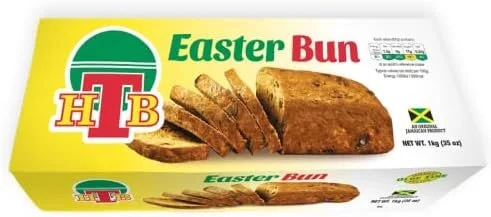 Package of Easter Bun with sliced bread and a loaf on it, labeled with the H.T.B. logo and Jamaican Green Marketing Board certification.