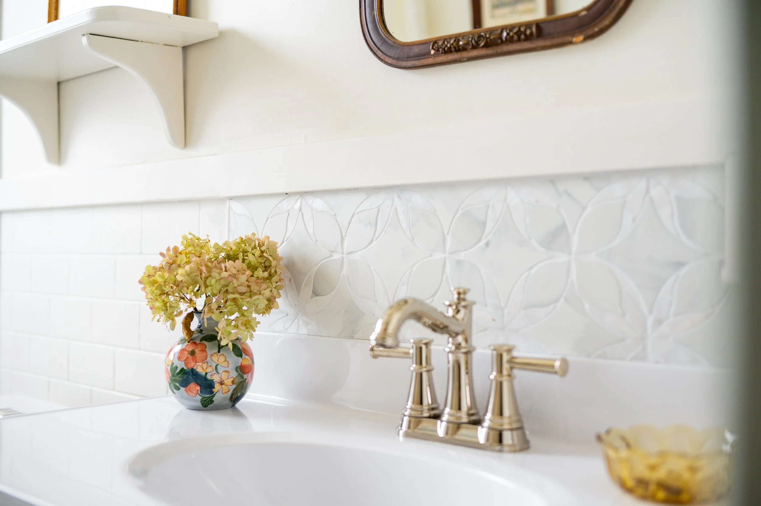 The sink backsplash was originally intended for flooring, until I realized it was for wall-installation only. Instead, I used it to create a sidesplash, ultimately wrapping it around the sink for a full backsplash, showcasing the beautiful pattern an