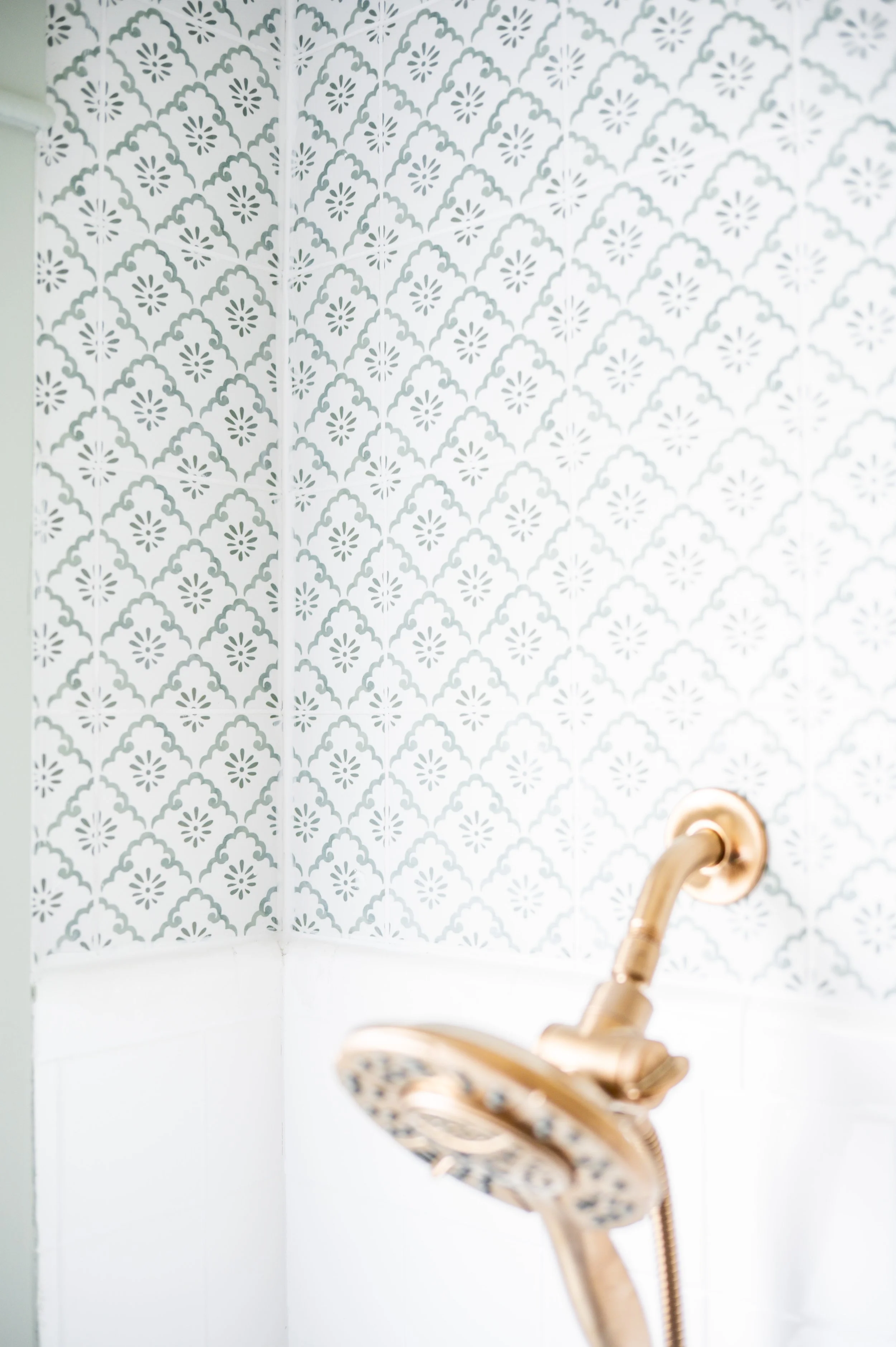Keeping the original bathtub and tile was never in question. Instead, the tub was refinished, fixtures replaced, and a new pattern took tile the rest of the way to the ceiling, actually the third choice after glass material from option one proved too