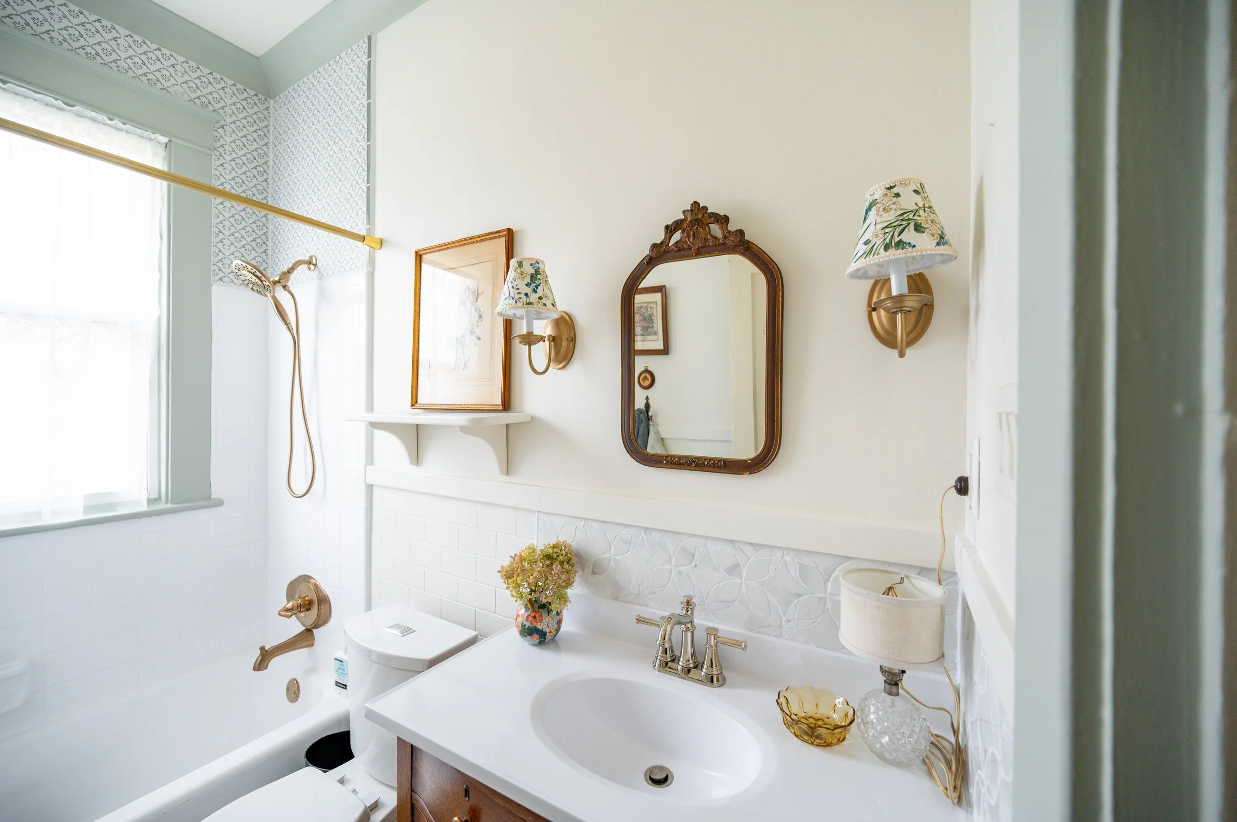 I thrifted, painted, and installed the little shelf myself. An in-wall medicine cabinet and over-sink light fixture, neither original to the house, were removed in favor of a little mirror from one of Lynchburg's vintage shops and affordable Home Dep