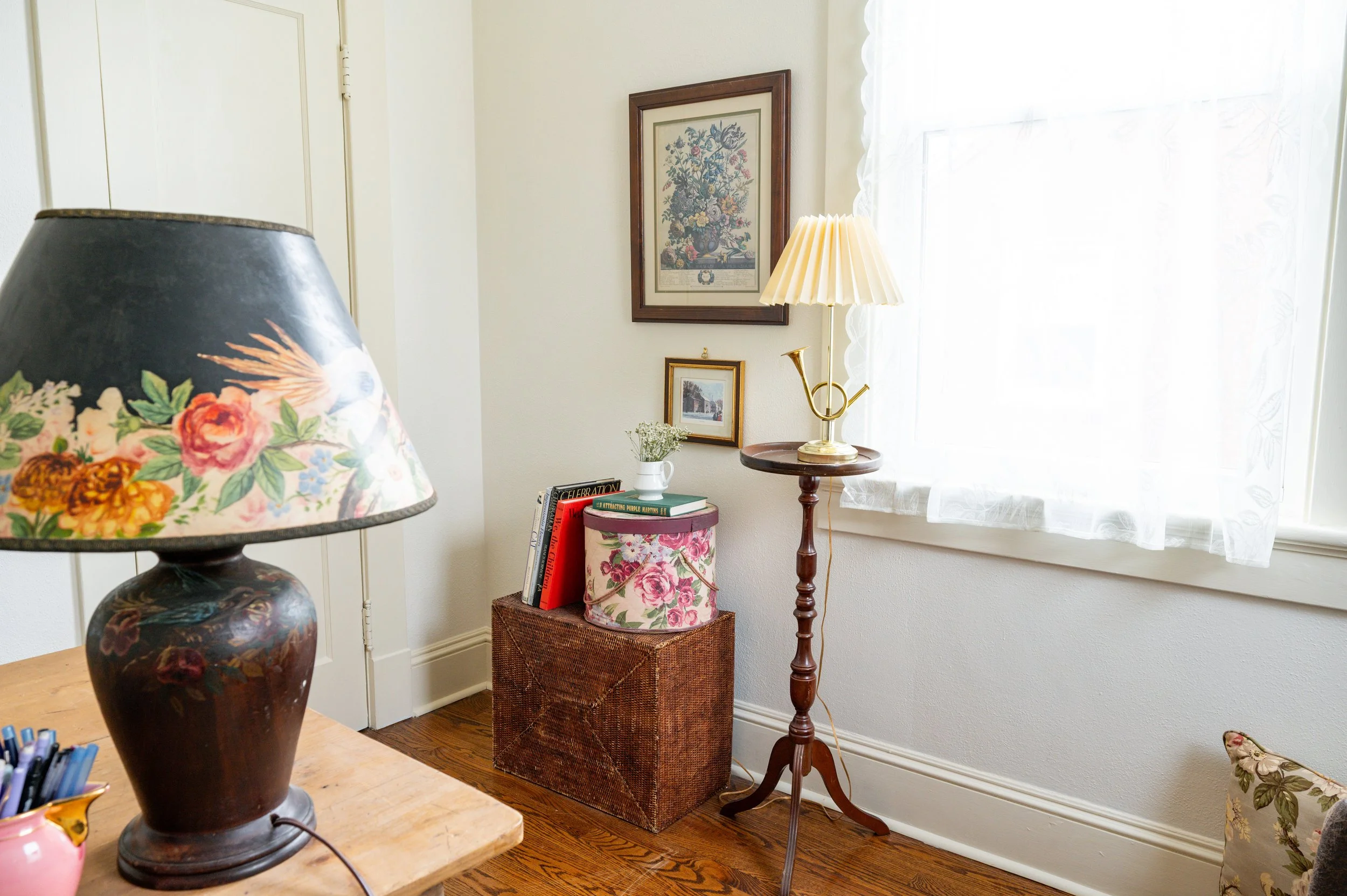 Both lamps are Facebook Marketplace finds, the larger with a hand-painted shade and base.  The basket-box is hiding internet wires and routers, and the floral hatbox is where Mom kept some of her sewing supplies, along with a few letters and pictures